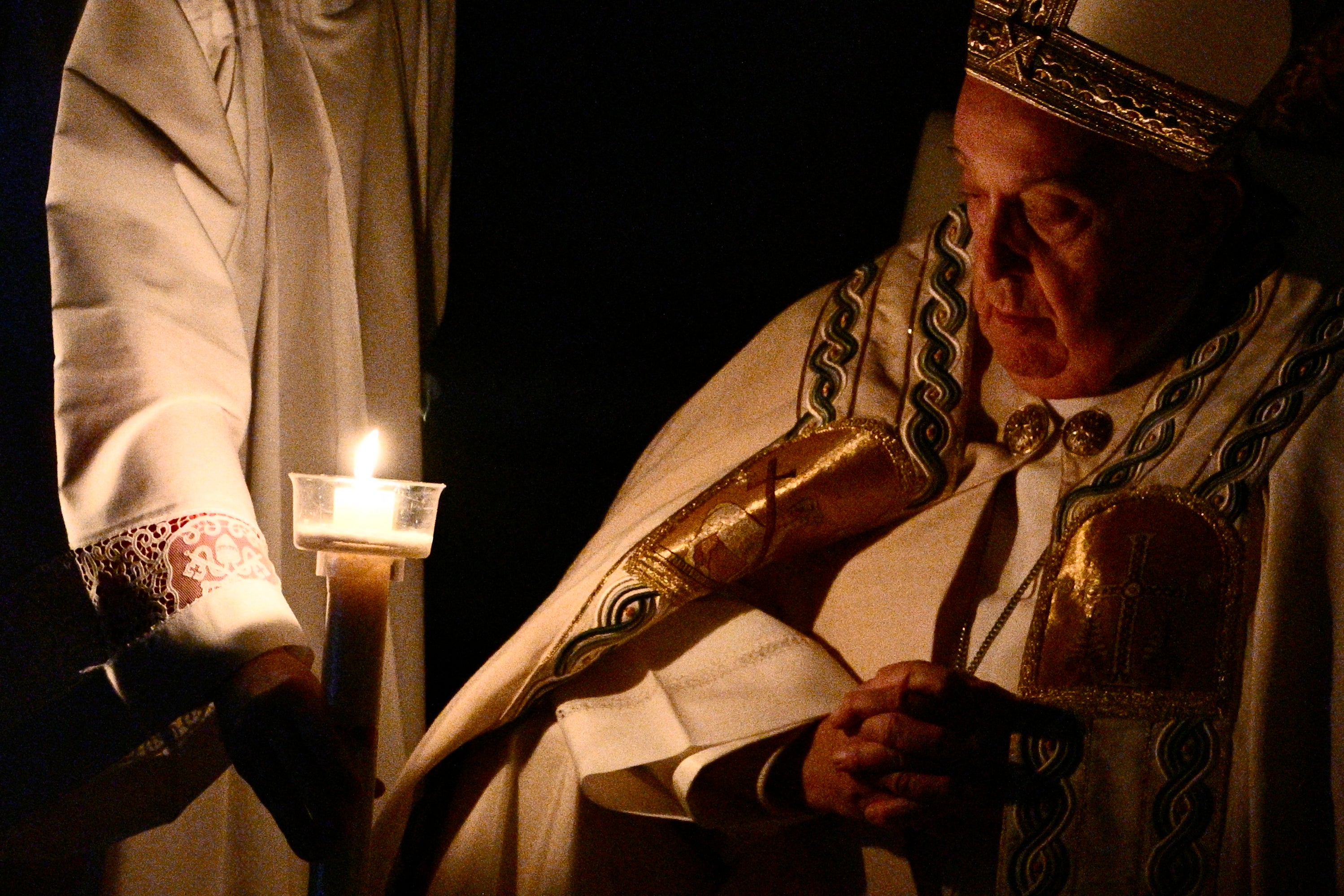 Pope Francis looks at his candle during the Easter Vigil