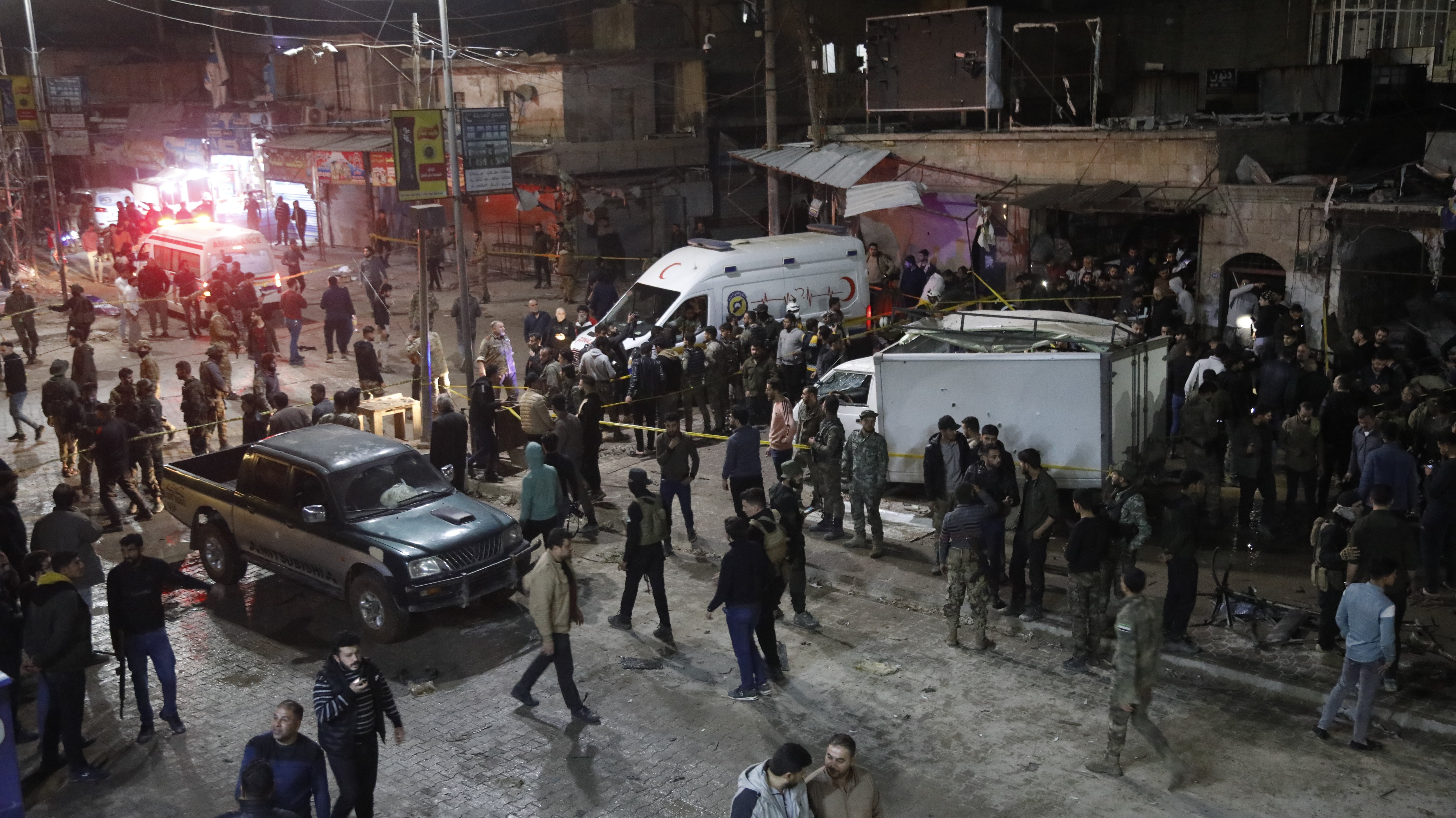 Security forces and ambulances are dispatched to the area after a bomb exploded in bustling market in area controlled by opposition forces in Azaz, Syria