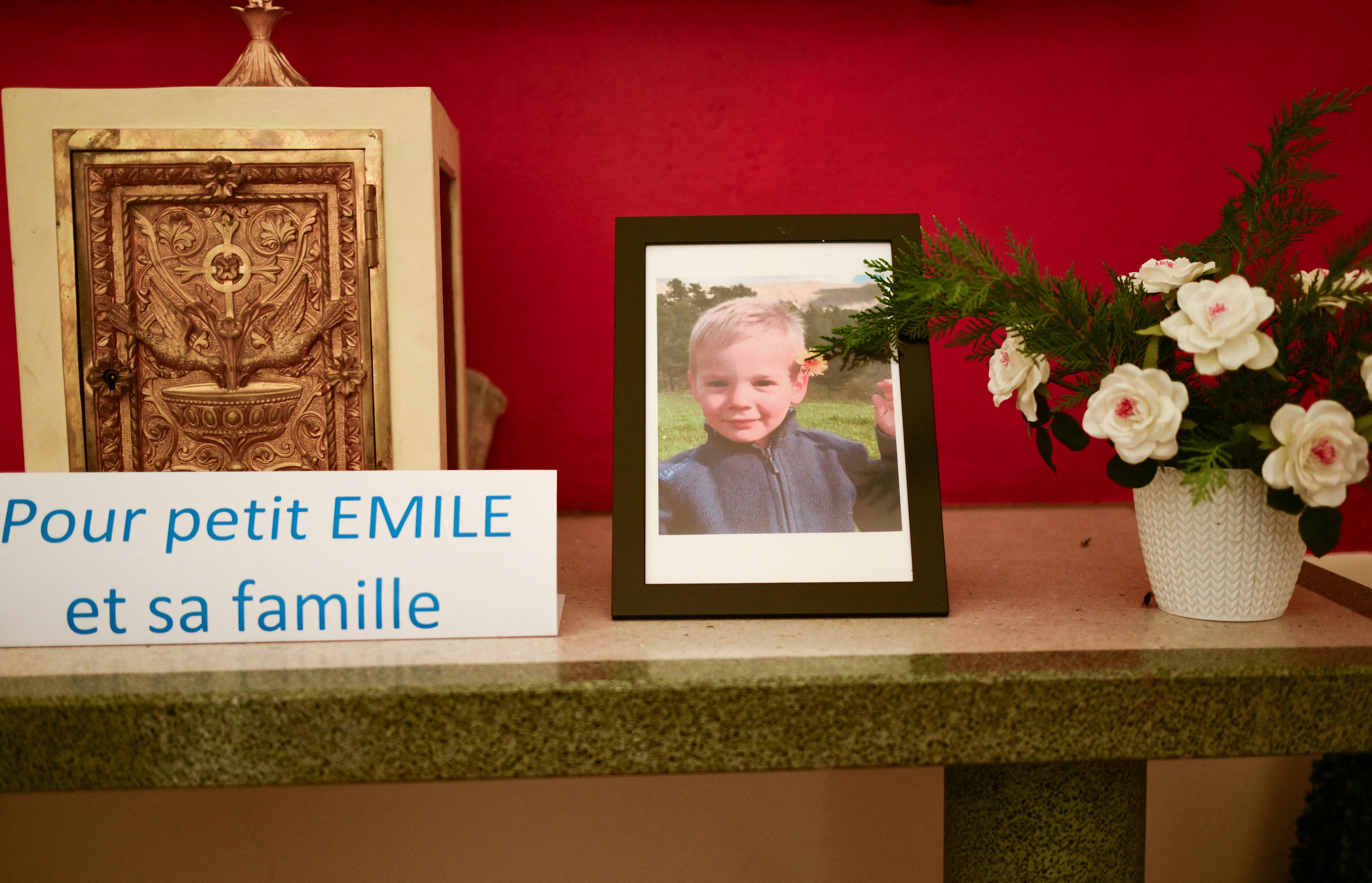 Inside a chapel in La Bouilladisse southern France, a card with the inscription reading ‘for little Emile and his family’ next to a photo of Emile