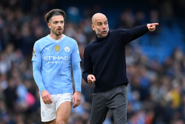 <p>Pep Guardiola speaks with Jack Grealish after the draw with Arsenal </p>
