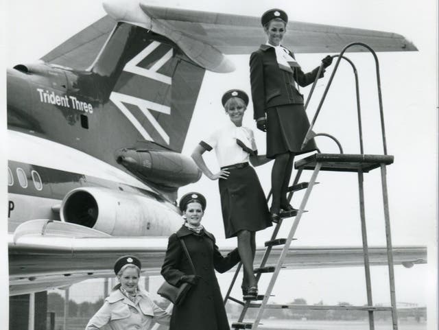 <p>British Airways cabin crew beside a Trident aircraft</p>