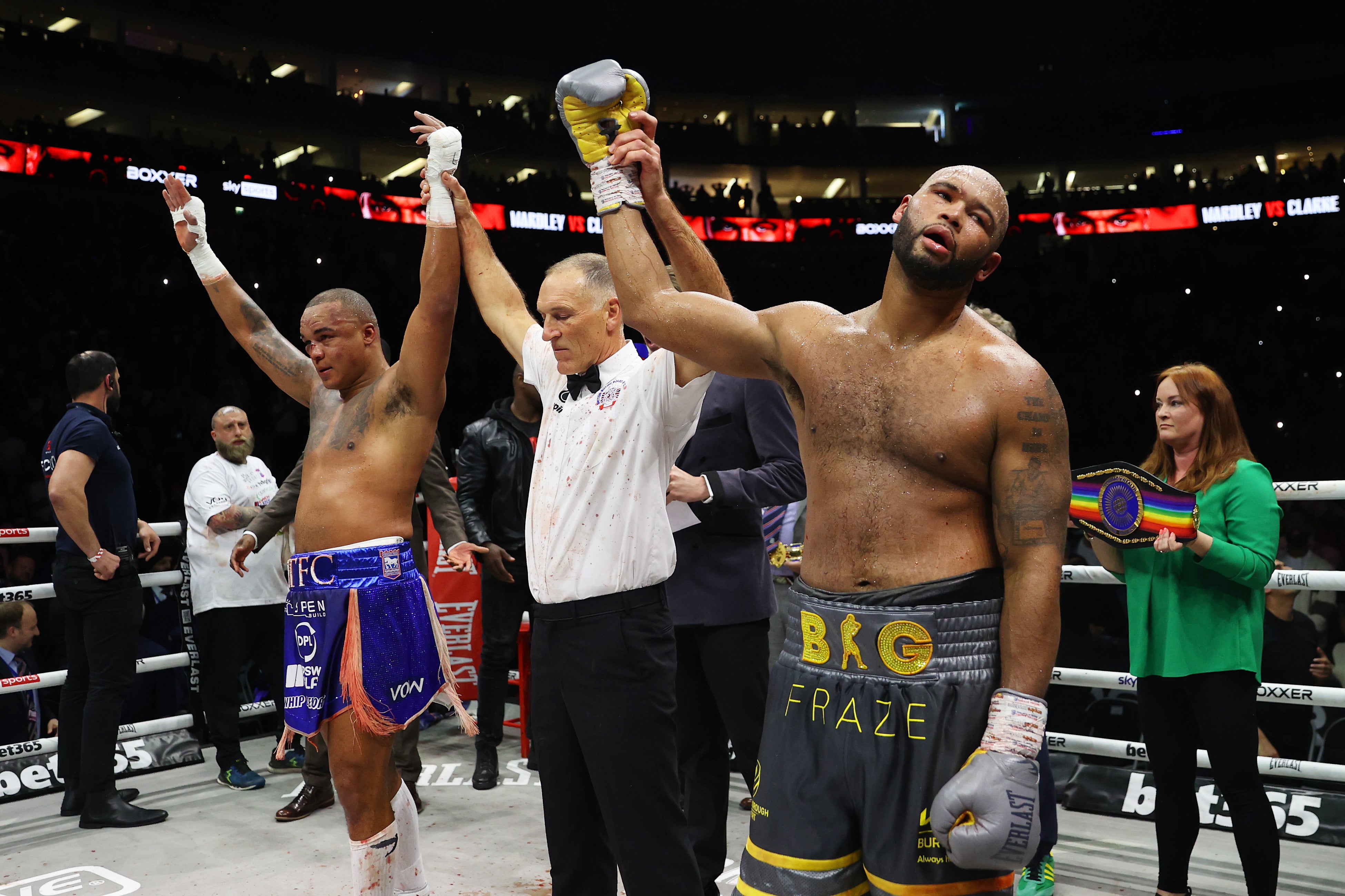 Referee Steve Gray raises the arms of both Fabio Wardley (left) and Frazer Clarke after announcing a draw at the O2 Arena on Sunday