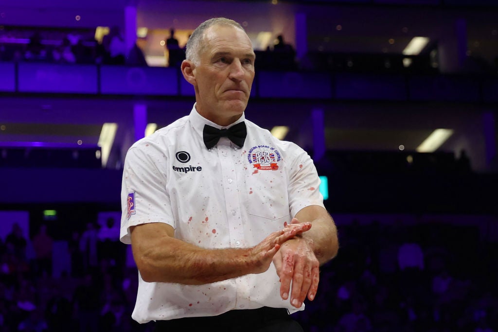 Blood splatters onto the white shirt of the referee, Steve Gray