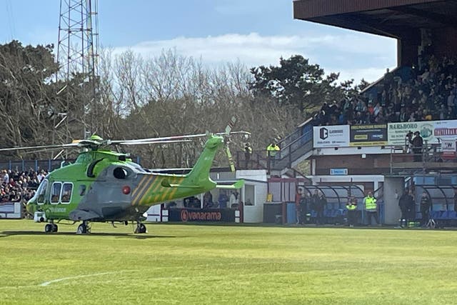 <p>An air ambulance lands on the pitch at the Bob Lucas Stadium </p>