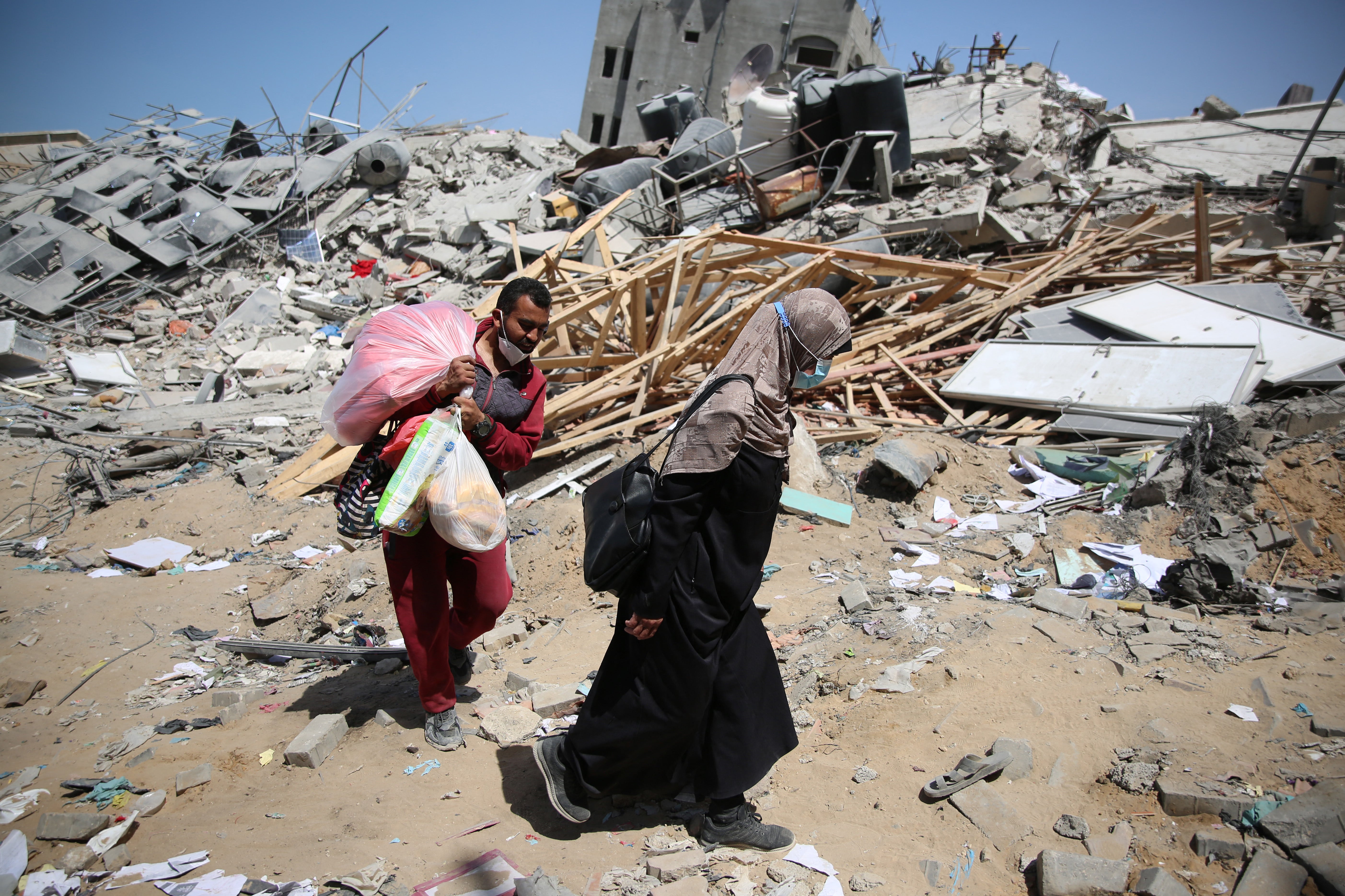 Two Palestinians walk amid rubble left by the Israeli assault on Shifa Hospital in northern Gaza