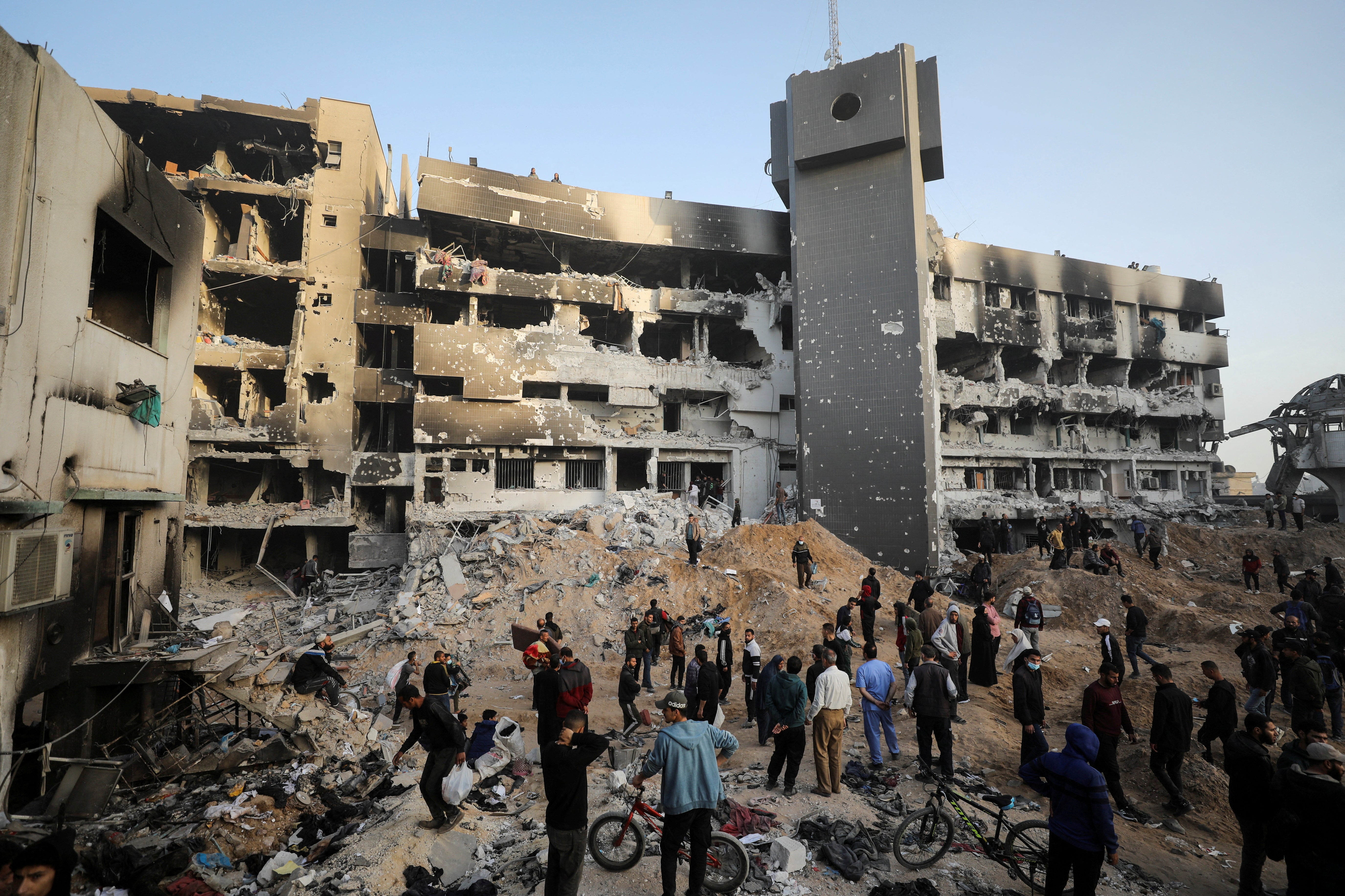 Palestinians inspect rubble surrounding Shifa hospital, where Israel claims Hamas militants hide with weapons and money