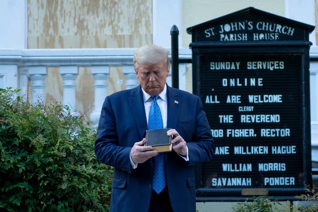 <p>Donald Trump holds a Bible while visiting St. John's Church across from the White House after the area was cleared of people protesting the death of George Floyd June 1, 2020, in Washington, DC</p>