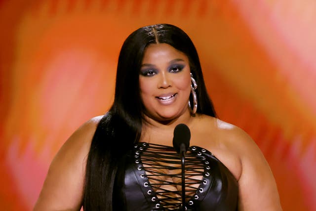 <p>Lizzo speaks onstage during the 66th GRAMMY Awards</p>