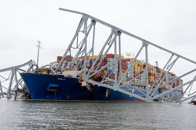 <p>Wreckage from collapsed Francis Scott Key Bridge rests on cargo ship Dali </p>