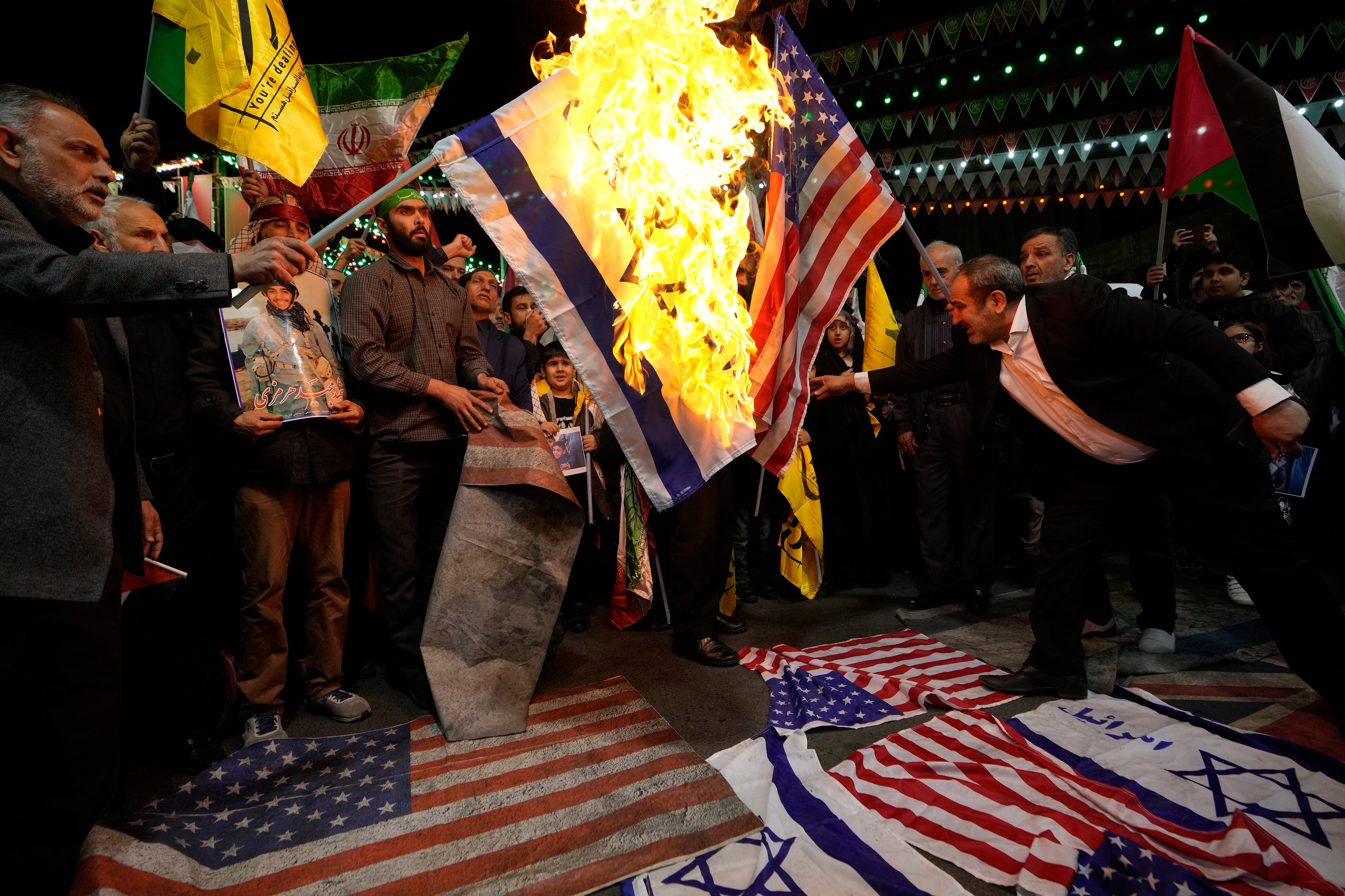 Iranian protesters burn US and Israeli flags after an airstrike on Tehran’s consulate in Syria