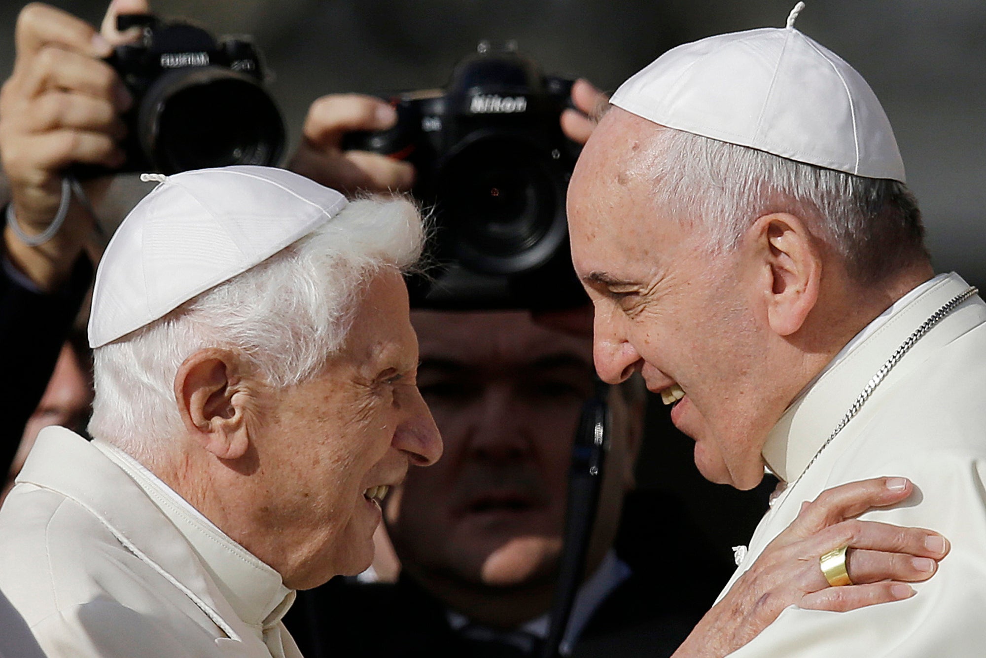 Pope Francis, right, hugs Emeritus Pope Benedict XVI