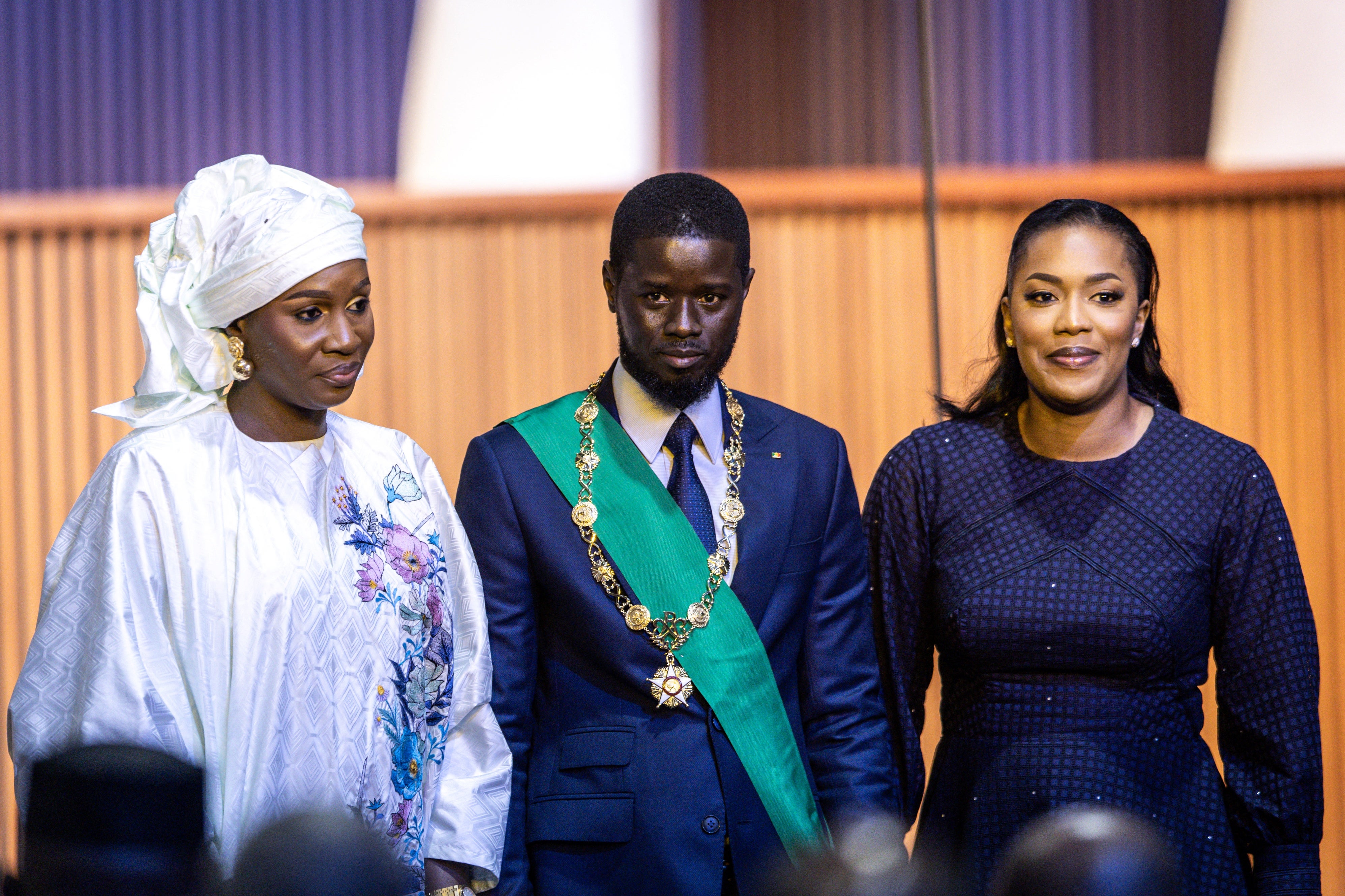 Bassirou Diomaye Faye with his wives Marie Khone Faye (L) and Absa Faye (R) at his swearing-in ceremony