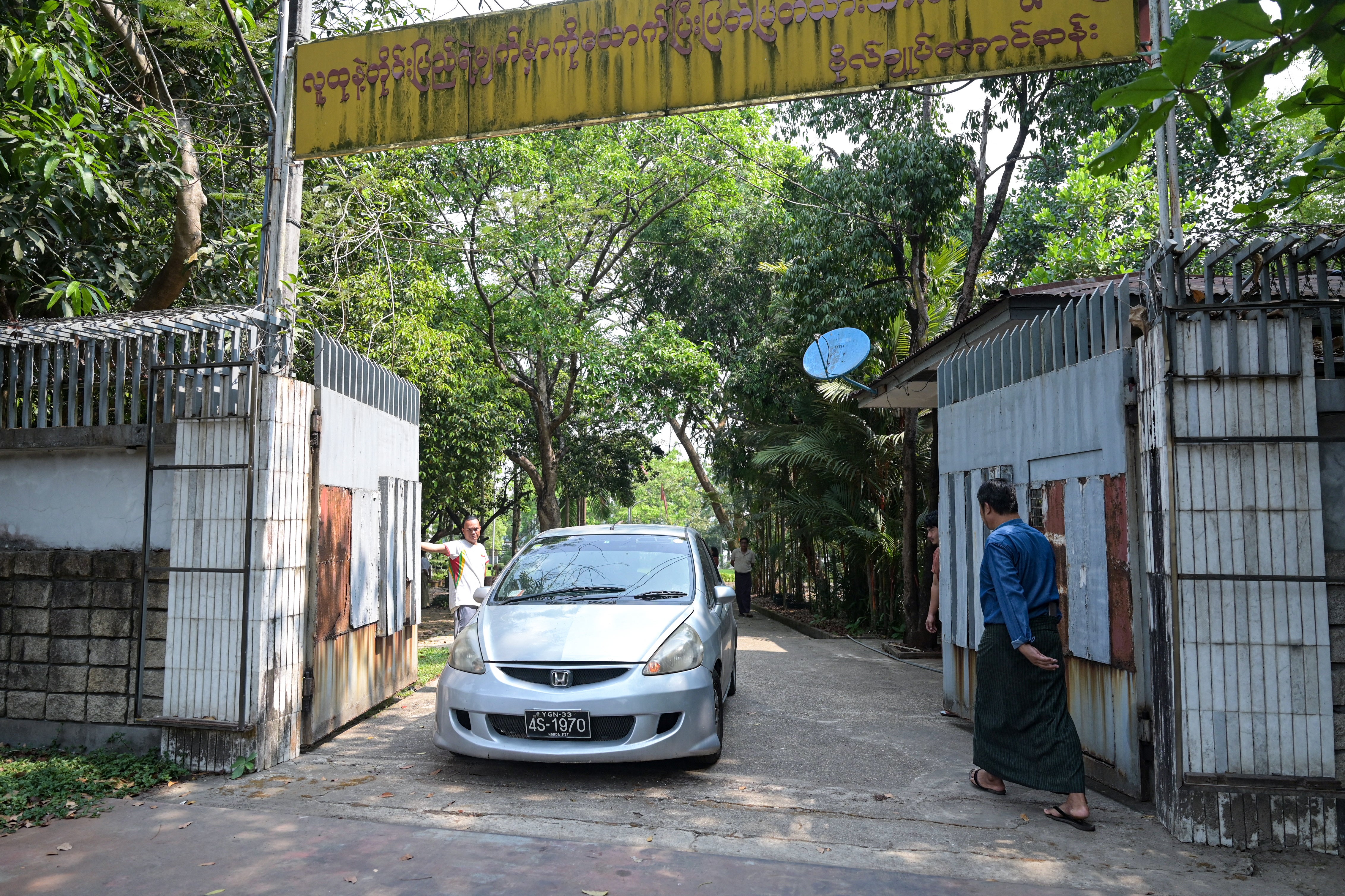 A car leaves the family house of detained Myanmar civilian leader Aung San Suu Kyi in Yangon on 20 March 2024.