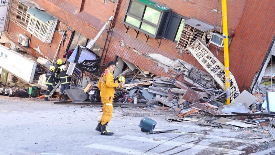 Rescuers work at a partially collapsed building