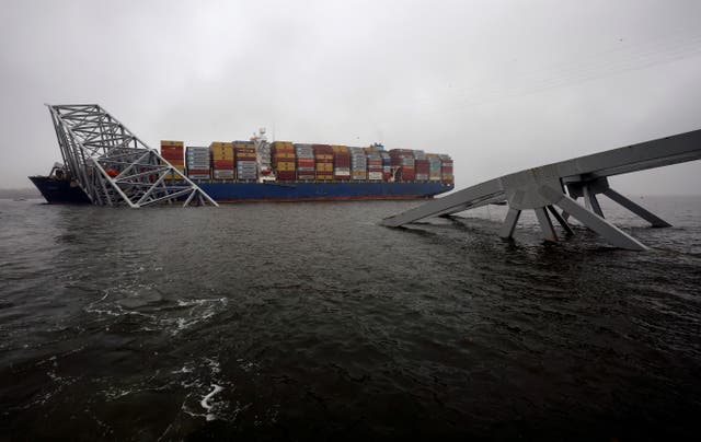 <p>Salvage personnel work to clear wreckage after the cargo ship Dali crashed into and collapsed the Francis Scott Key Bridge, on April 2, in Baltimore, Maryland. </p>