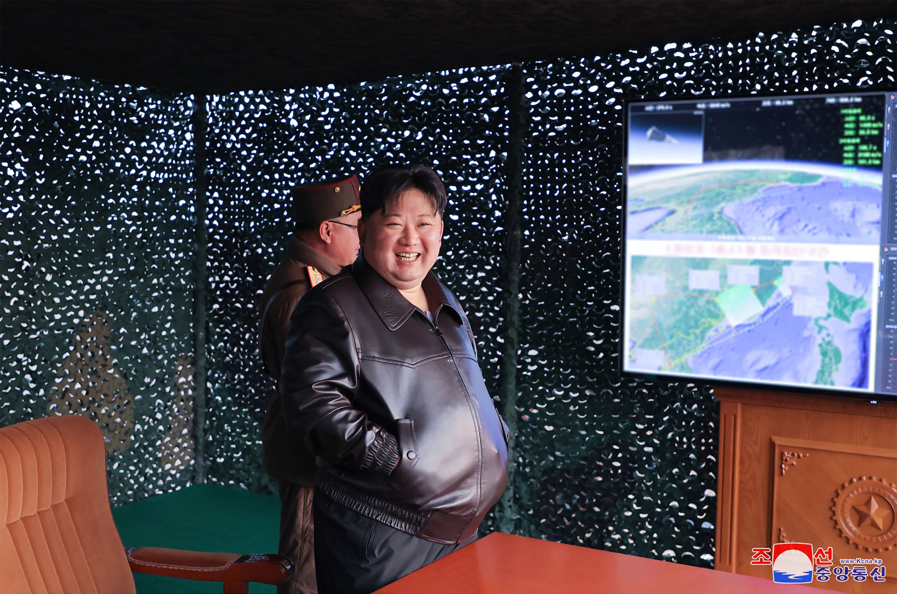Kim Jong-un looks delighted during the missile launch on Tuesday