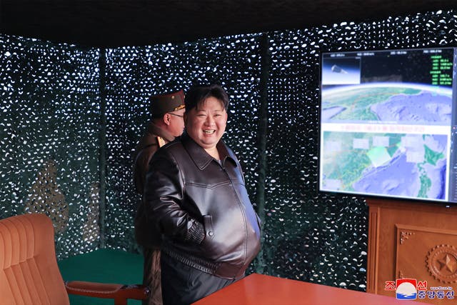 <p>Kim Jong-un looks delighted during the missile launch on Tuesday </p>