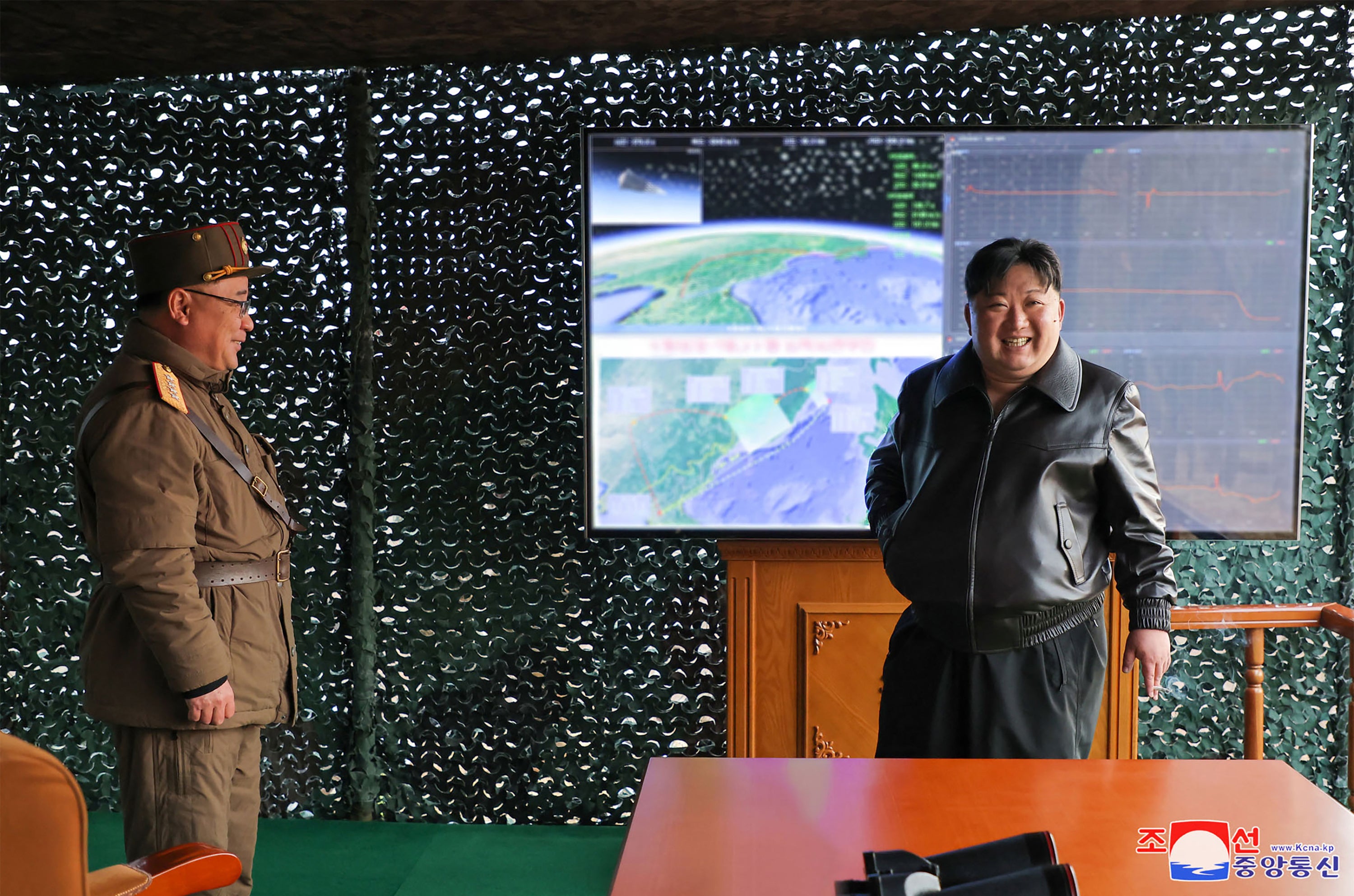 This picture taken on 2 April 2024 and released by North Korea’s official Korean Central News Agency (KCNA) on 3 April shows North Korean leader Kim Jong-un (R) inspecting the first test-fire of Hwasongpho-16B at suburbs of Pyongyang in North Korea
