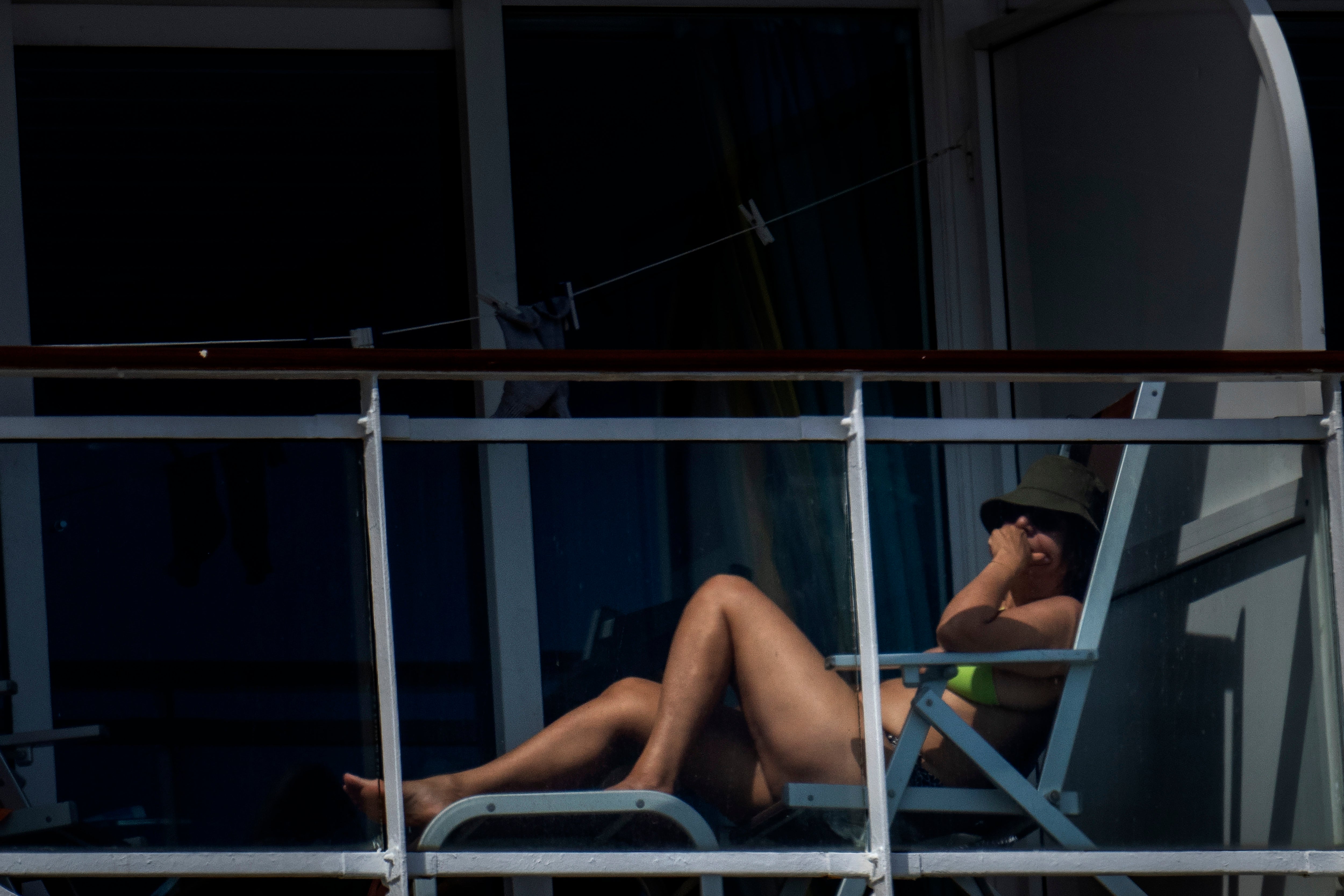 A passenger is photographed on the cruise ship MSC Armony, moored in the port of Barcelona