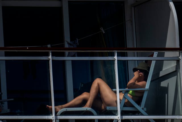 <p>A passenger is photographed on the cruise ship MSC Armony, moored in the port of Barcelona</p>