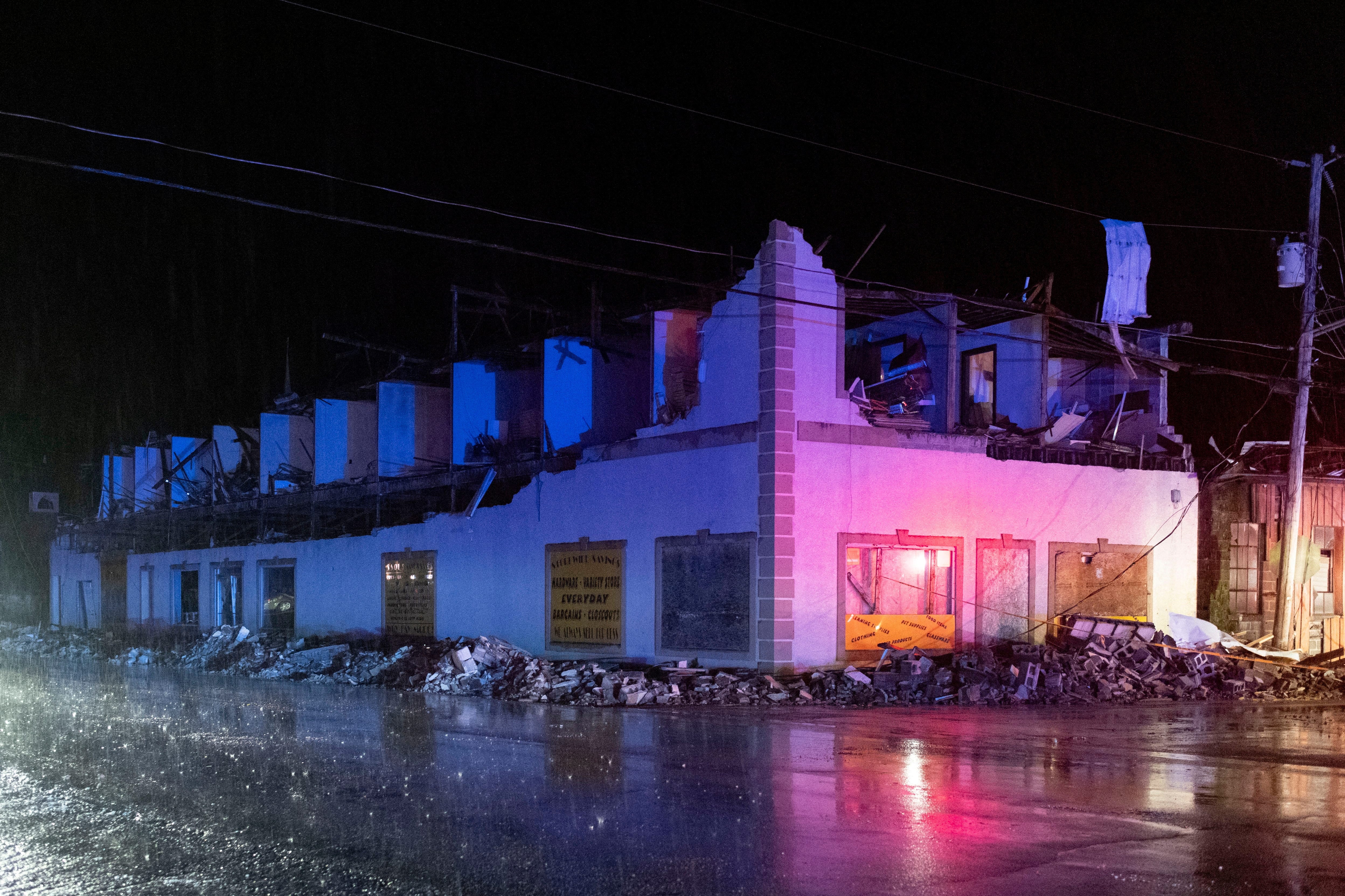 Emergency vehicle lights illuminate a building damaged due to a possible tornado touching down in Sunbright, Tennessee, U.S., April 2, 2024