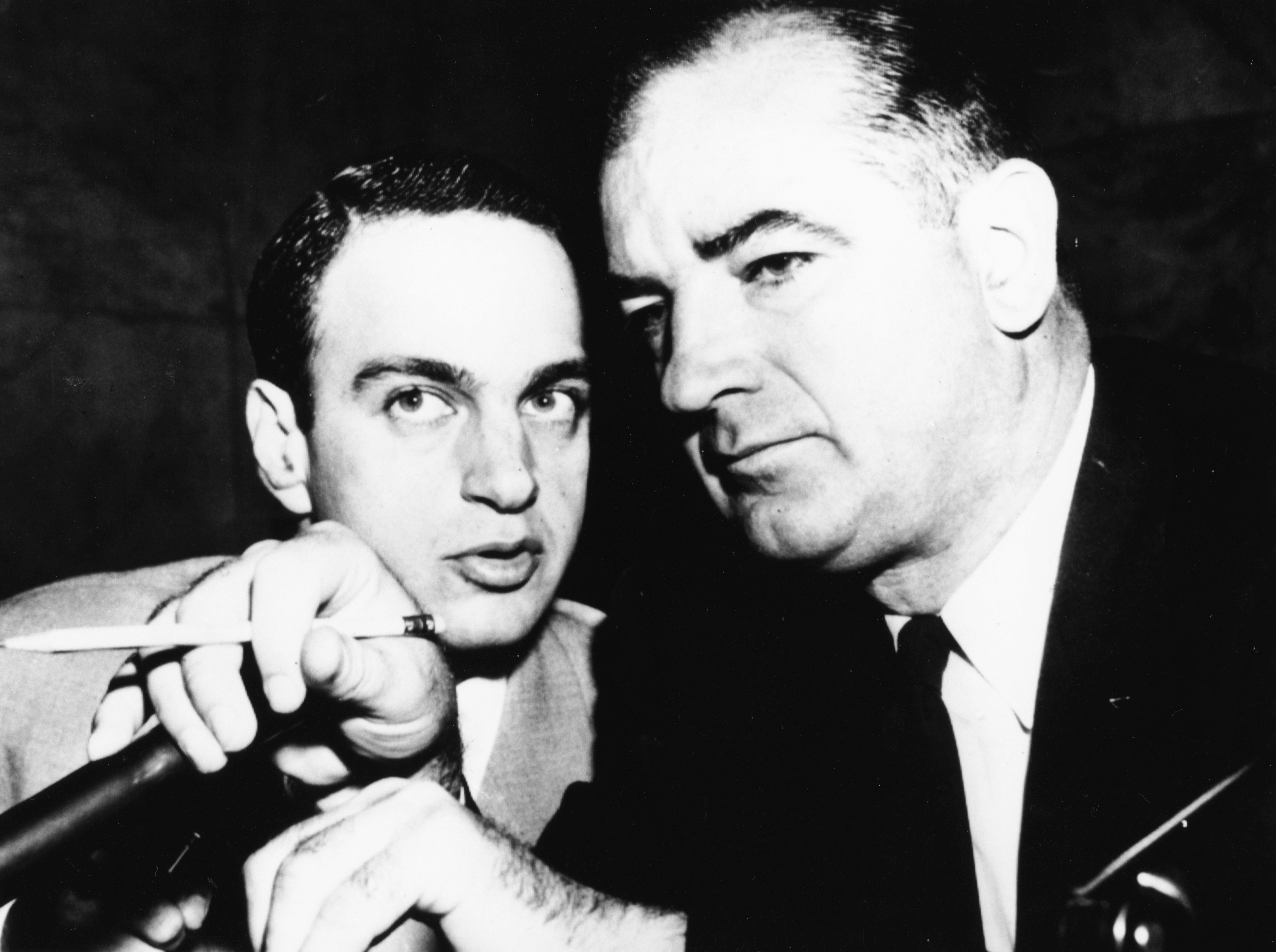 Attorney Roy Cohn, left, talking to American senator Joseph McCarthy, circa 1954