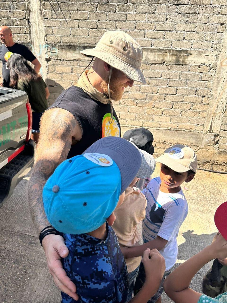 Jacob Flickinger hugging children in Acapulco while on a WCK mission