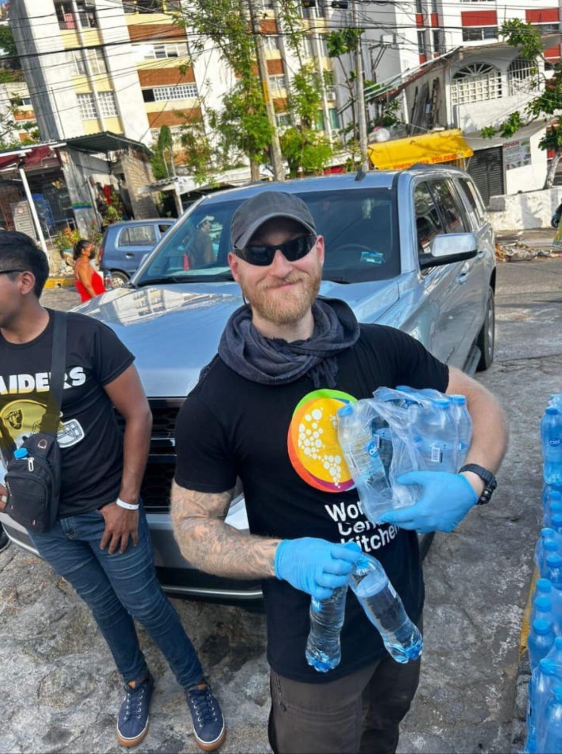 Jacob Flickinger posing while holding water bottles to distribute in Mexico
