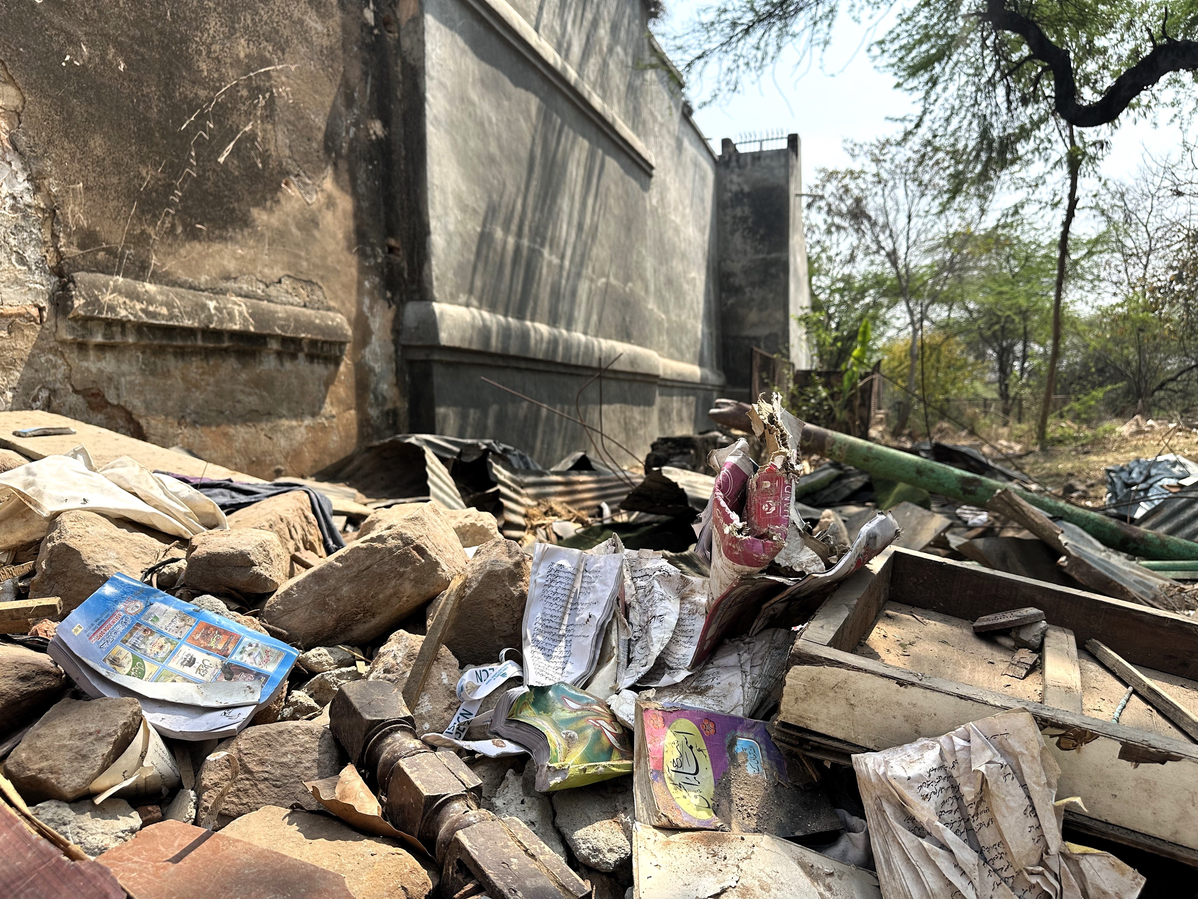 Rubble from the Akhoondji Mosque strewn with books from the associated Islamic school