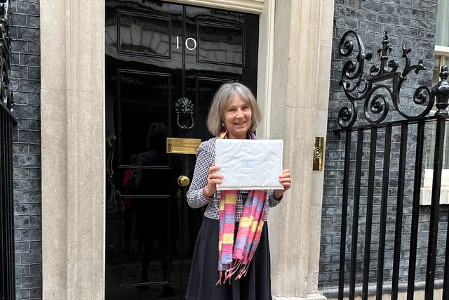 <p>Dr Susan Michaelis delivering a petition to 10 Downing Street </p>