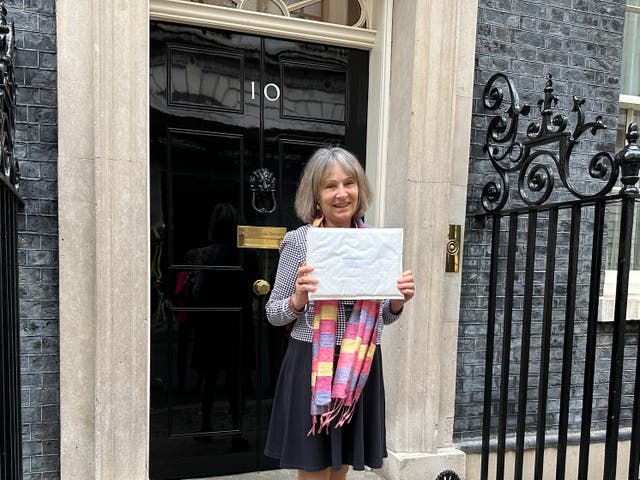 <p>Dr Susan Michaelis delivering a petition to 10 Downing Street </p>
