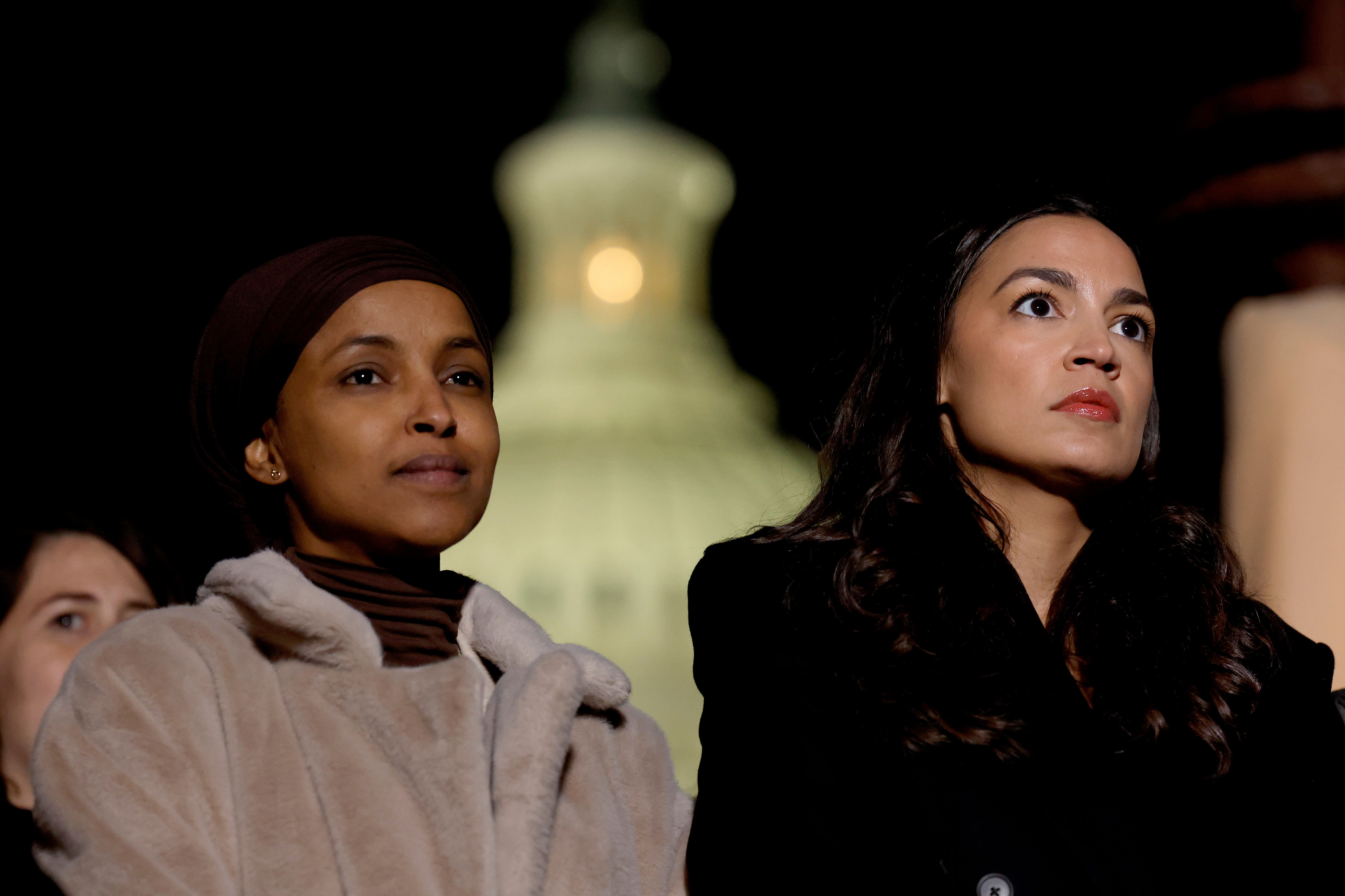 WASHINGTON, DC - NOVEMBER 13: (L-R) U.S. Rep. Ilhan Omar (D-MN) and Alexandria Ocasio-Cortez (D-NY) listen during a news conference calling for a ceasefire in Gaza outside the U.S. Capitol building on November 13, 2023 in Washington, DC. House Democrats held the news conference alongside rabbis with the activist group Jewish Voices for Peace. (Photo by Anna Moneymaker/Getty Images)