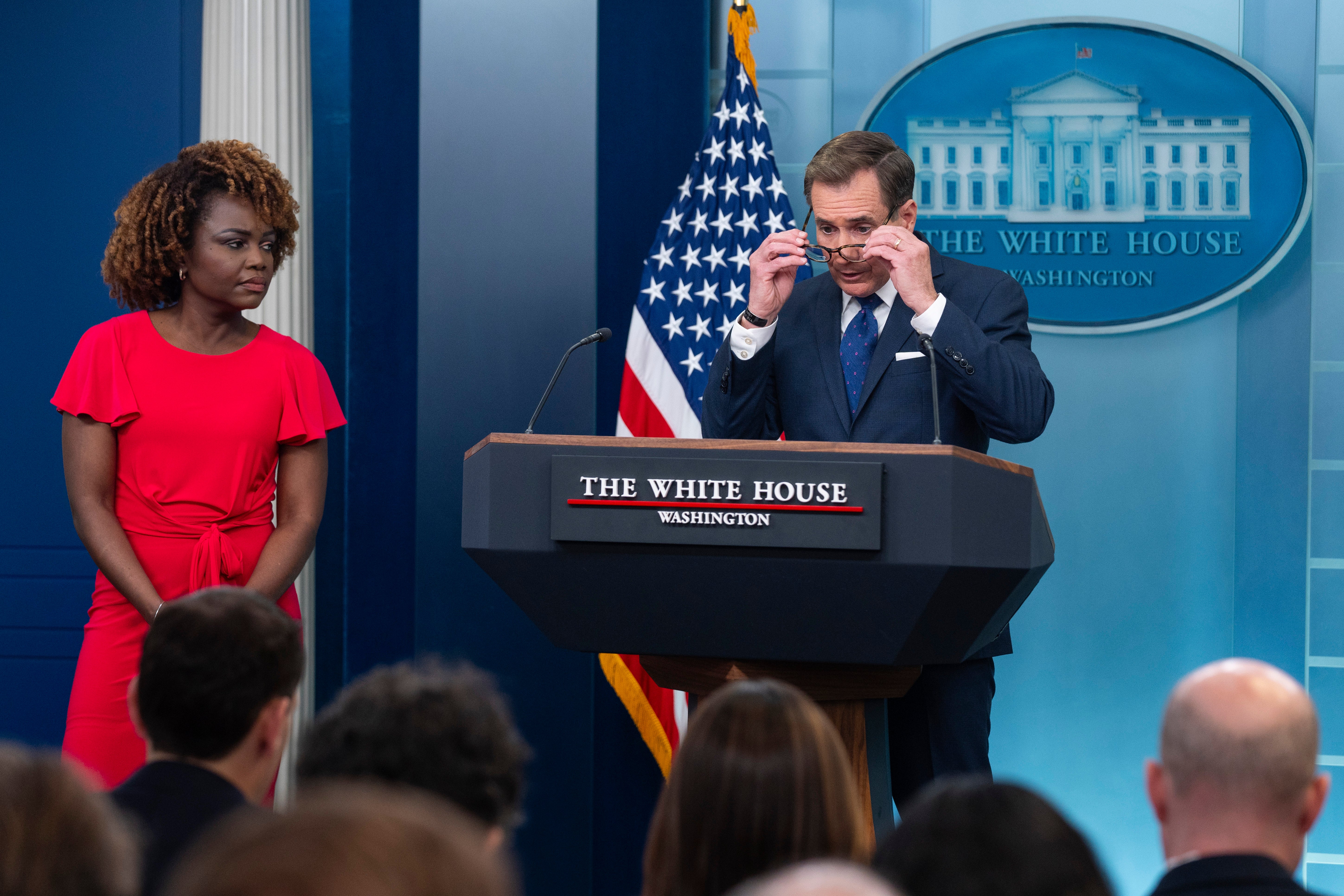 White House press secretary Karine Jean-Pierre listens as White House national security communications adviser John Kirby speaks during a press briefing at the White House in April
