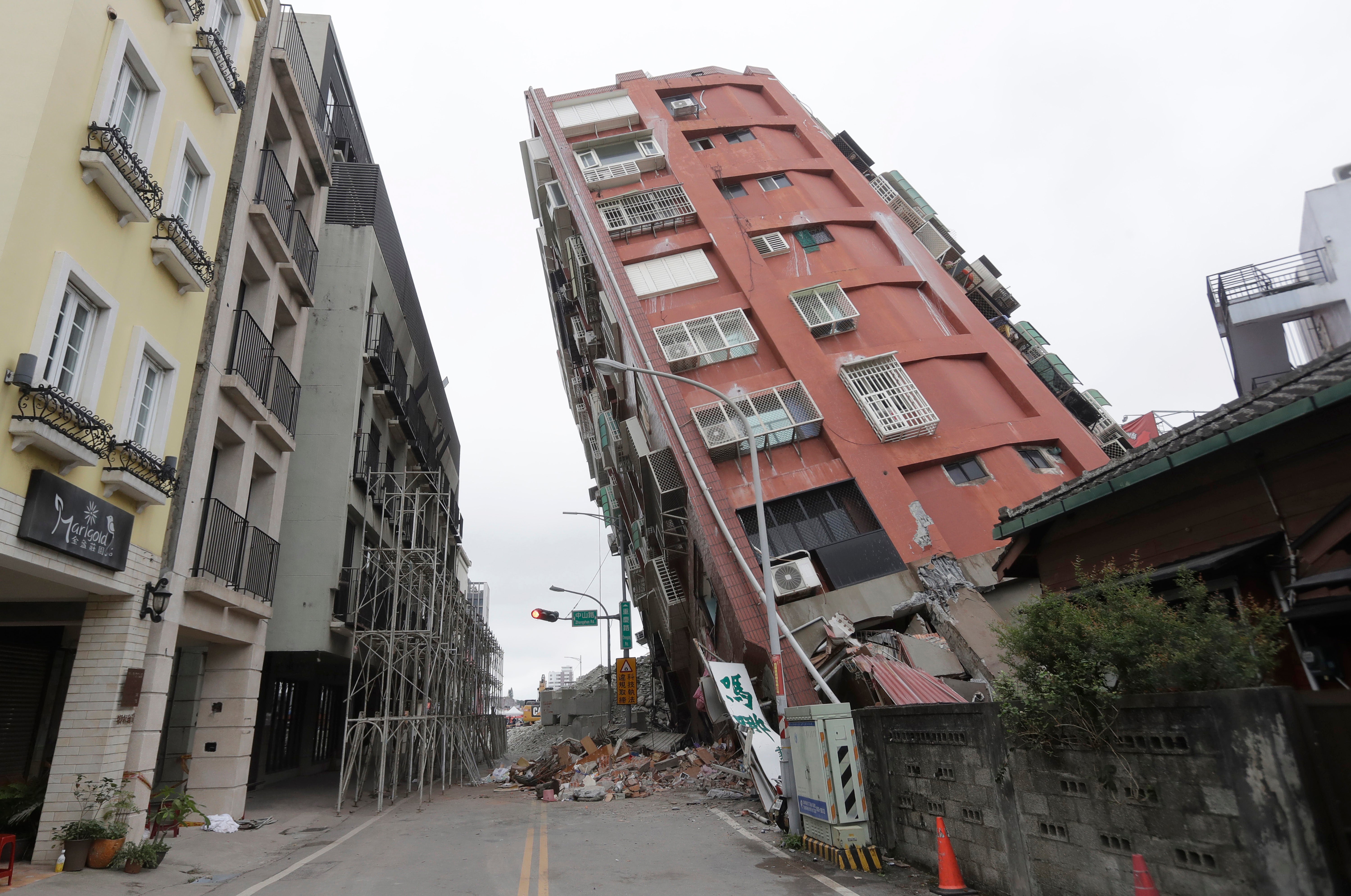 A building is seen partially collapsed, two days after a powerful earthquake struck the city, in Hualien City, eastern Taiwan