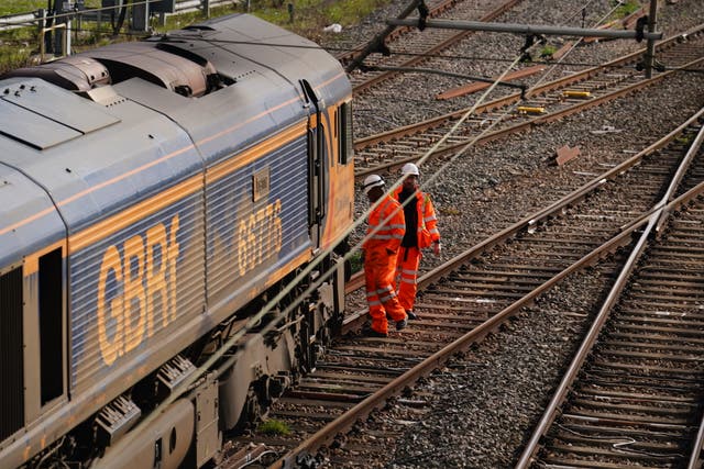 <p>Railway workers at the scene of a freight train derailment in West Ealing</p>