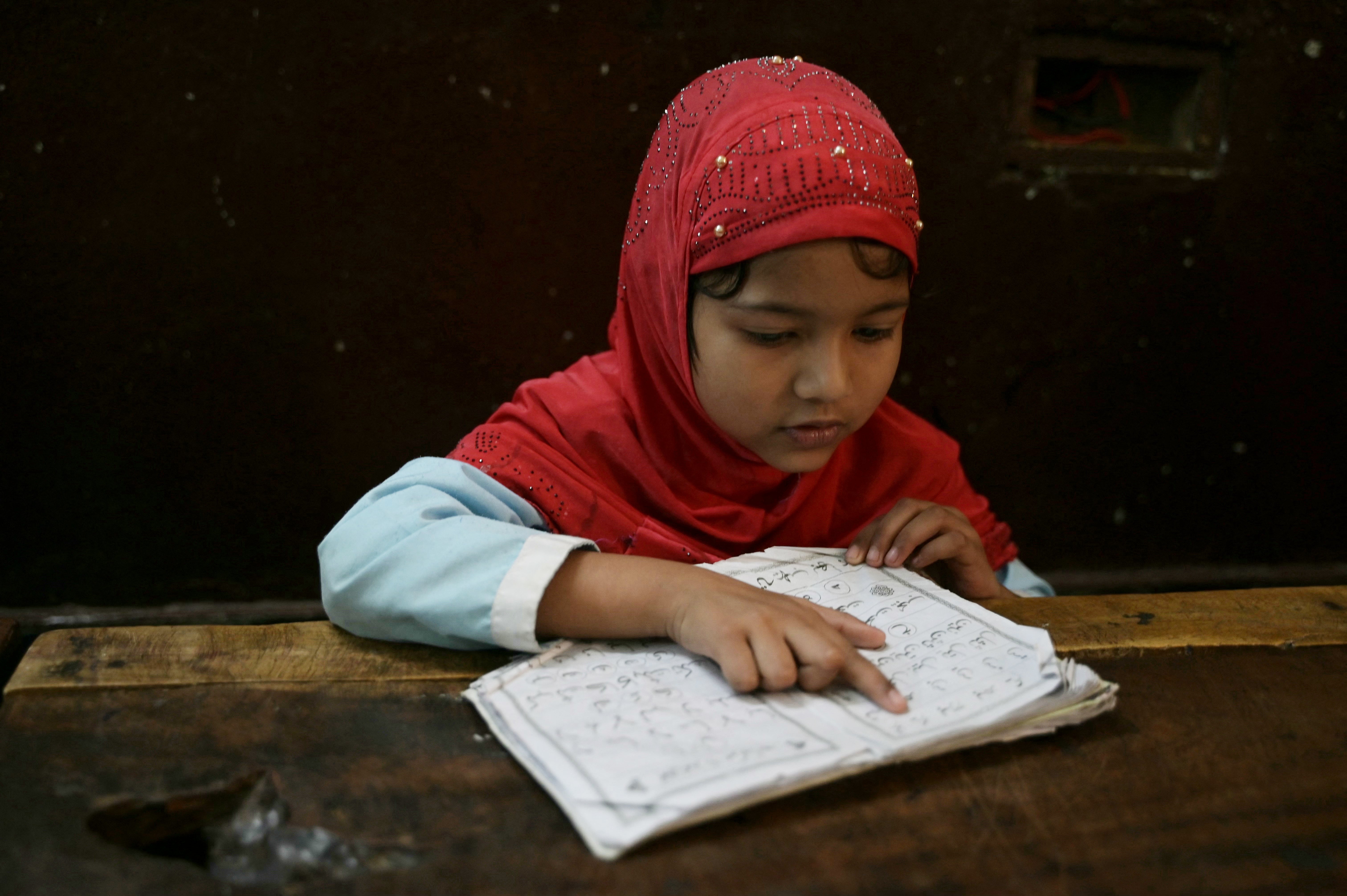 A student recites the Holy Quran in a classroom during the Islamic holy month of Ramadan at the Madrasatur-Rashaad religious school in Hyderabad