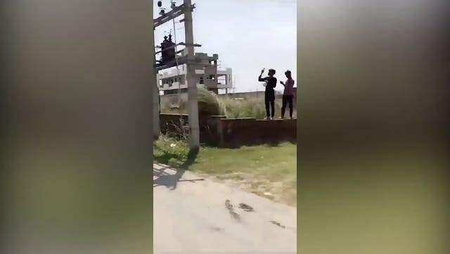 <p>Woman climbs 24-metre electricity pole after partner row.</p>