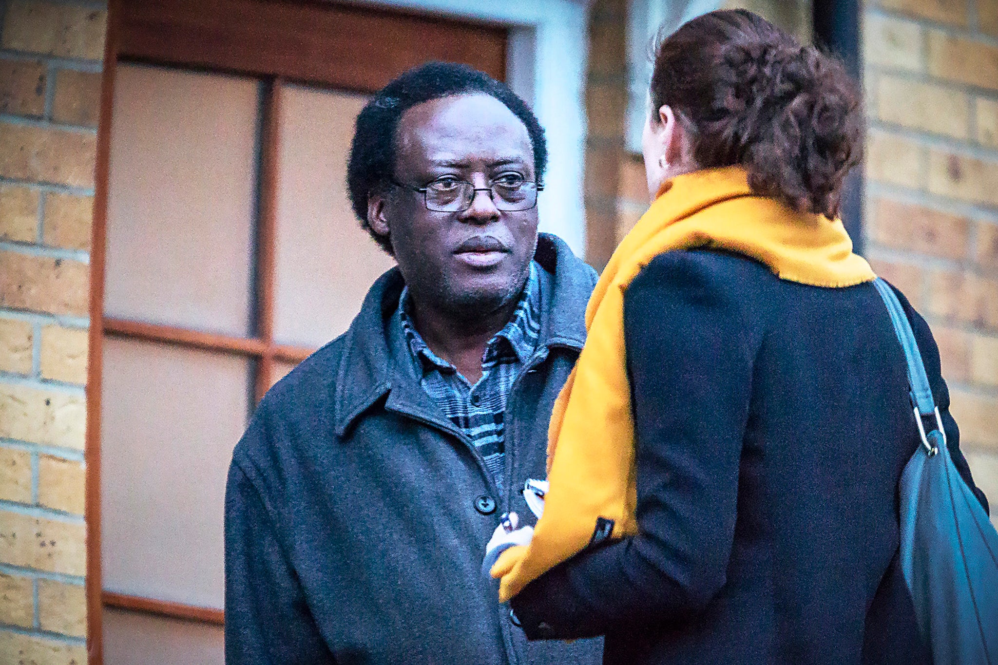Reporter Amy-Clare Martin approaches suspect Celestin Mutabaruka in 2019