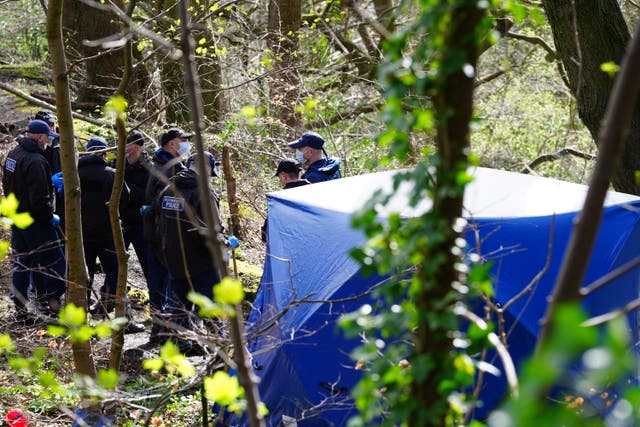 <p>Police officers by a forensic tent at Kersal Dale, near Salford, Greater Manchester, where a major investigation has been launched after human remains were found on Thursday evening</p>