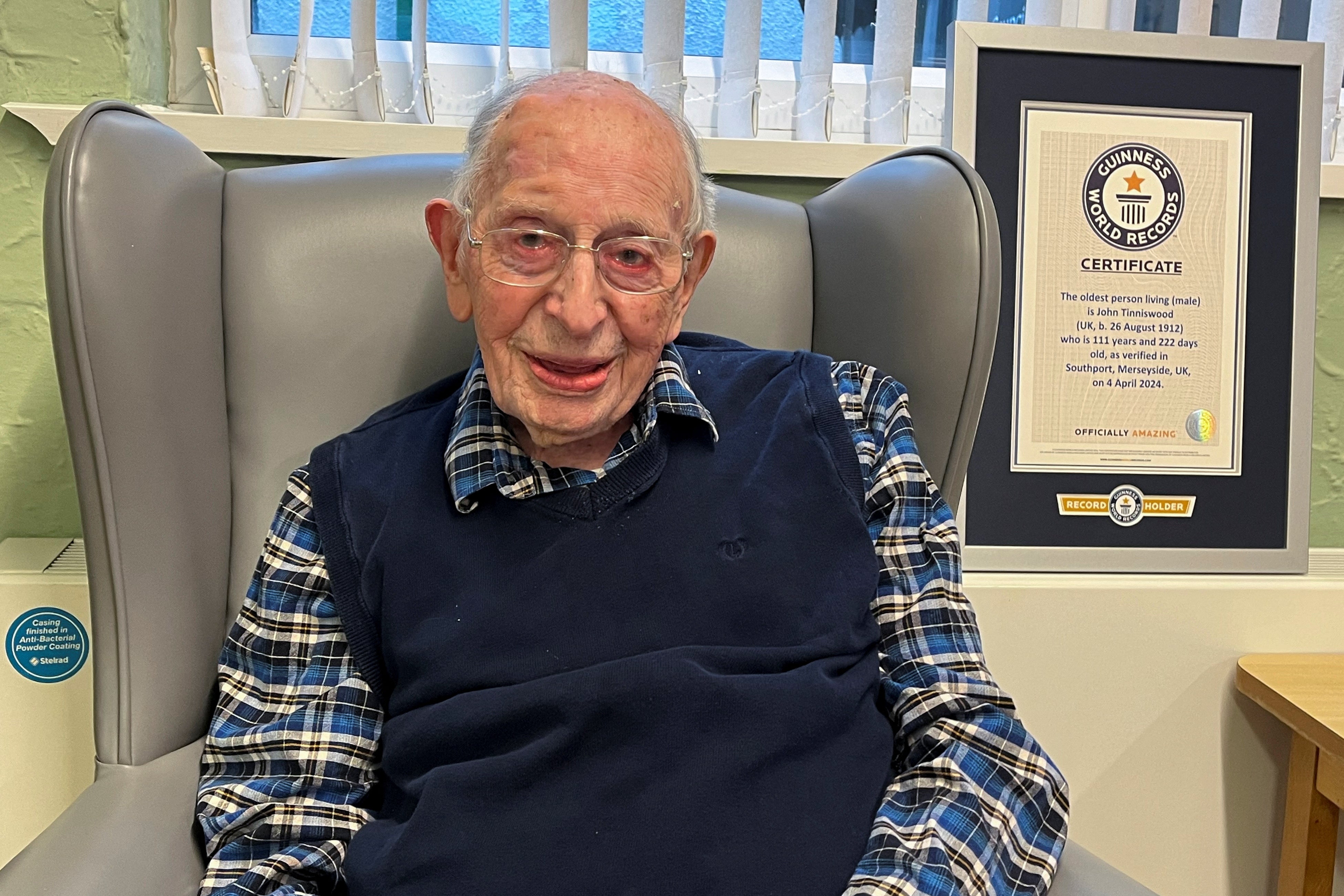 John Tinniswood poses with his certificate from the Guinness World Records