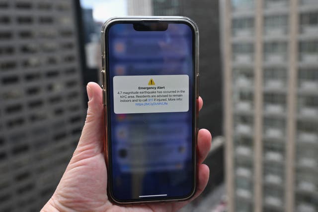 <p>File: A phone shows an Emergency Alert message warning of an earthquake in New York</p>