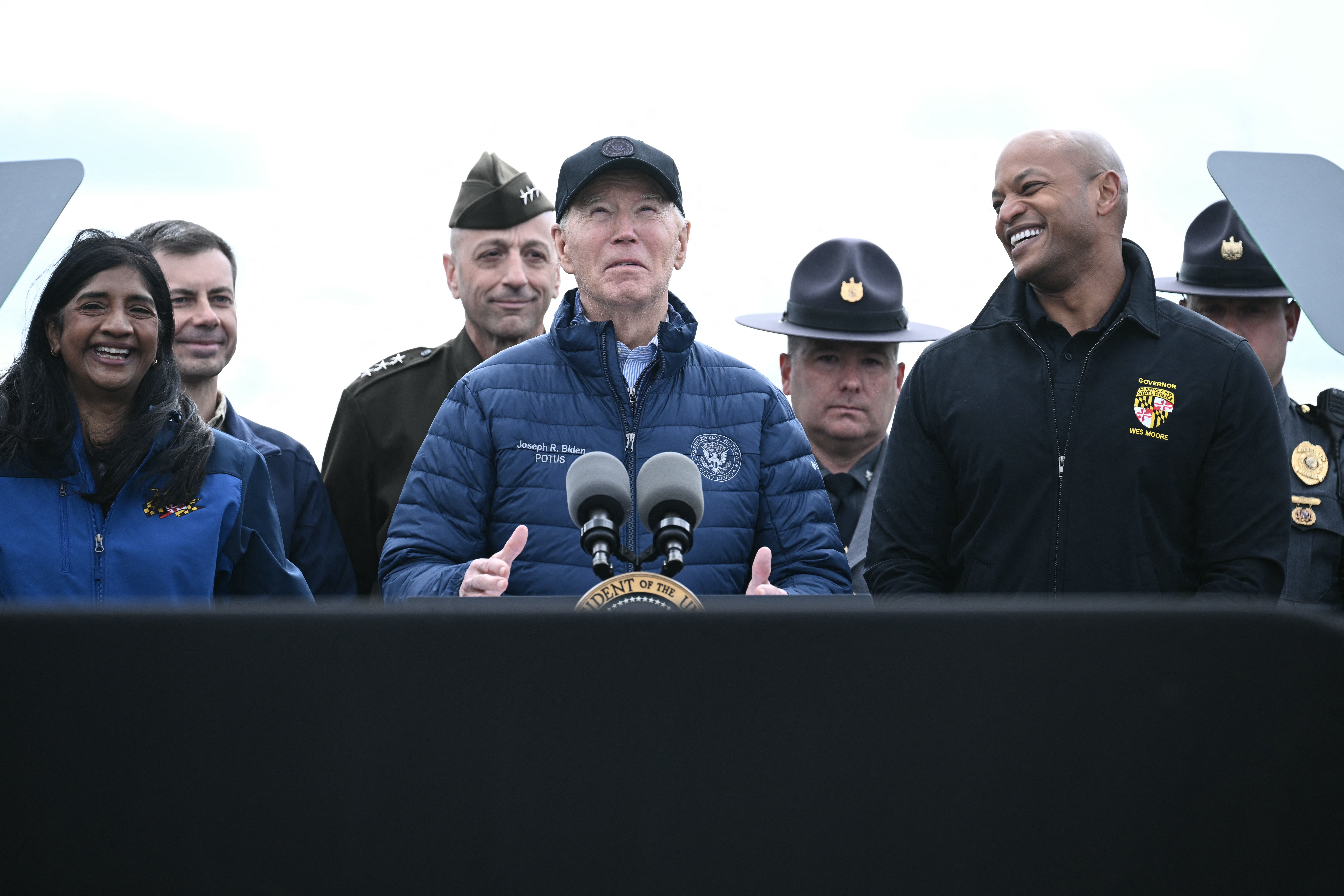 <p>US President Joe Biden speaks about the collapse of the Francis Scott Key Bridge after it was struck by the container ship Dali, as Maryland Governor Wes Moore (R) looks on in Baltimore, Maryland, on April 5, 2024</p>
