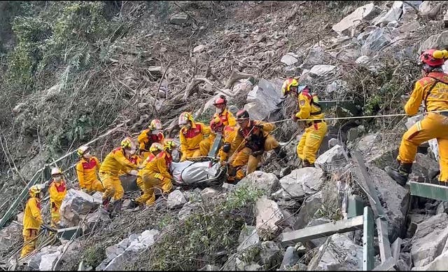 <p>in this photo taken Thursday, 4 April 2024 and released by Pingtung Fire Department, firefighters evacuate a body from the Taroko National Park a day after a powerful earthquake struck, in the Hualien county, eastern Taiwan</p>