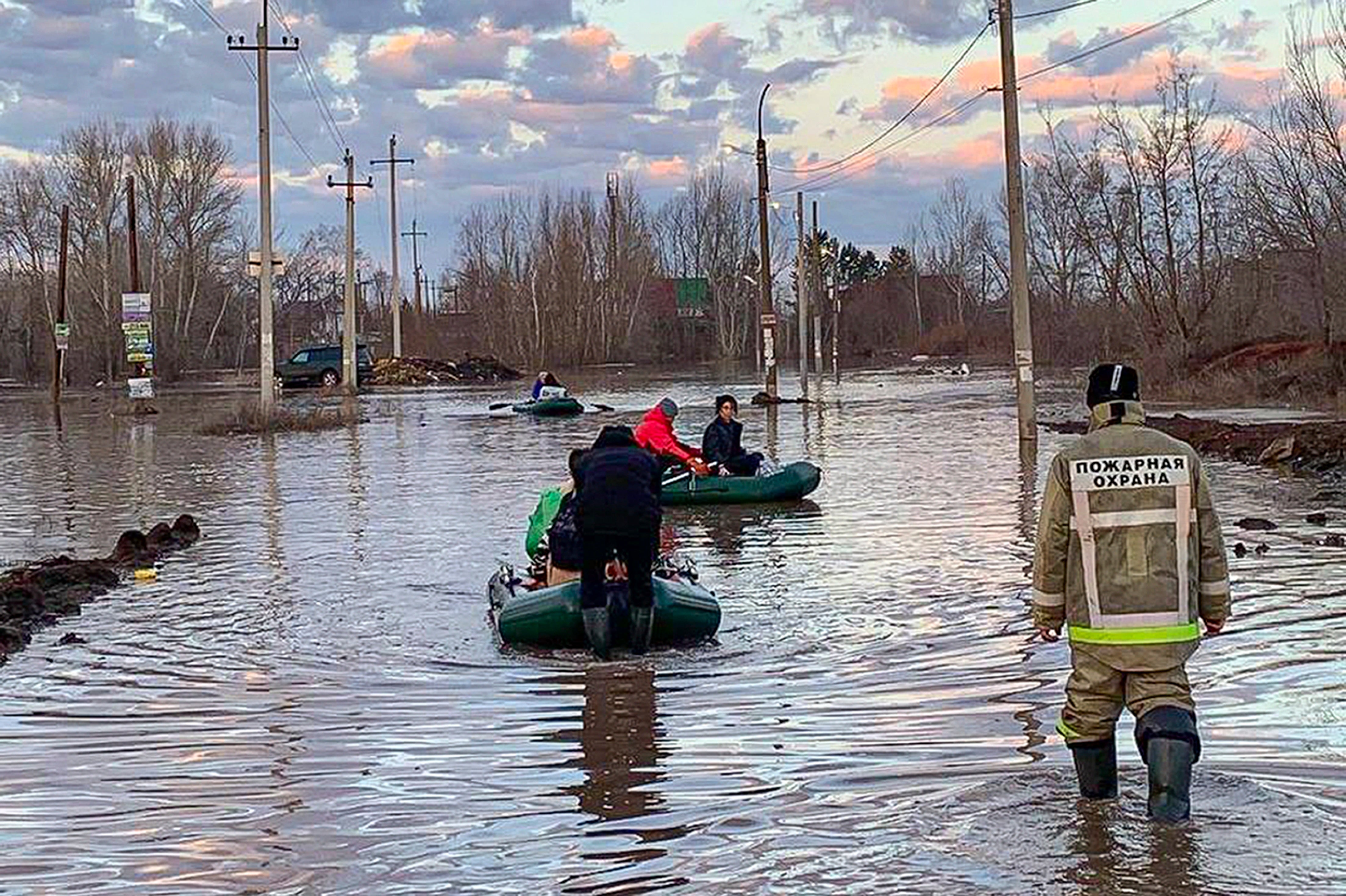 <p>People use boats after a dam burst caused flooding in Orsk, Russia</p>