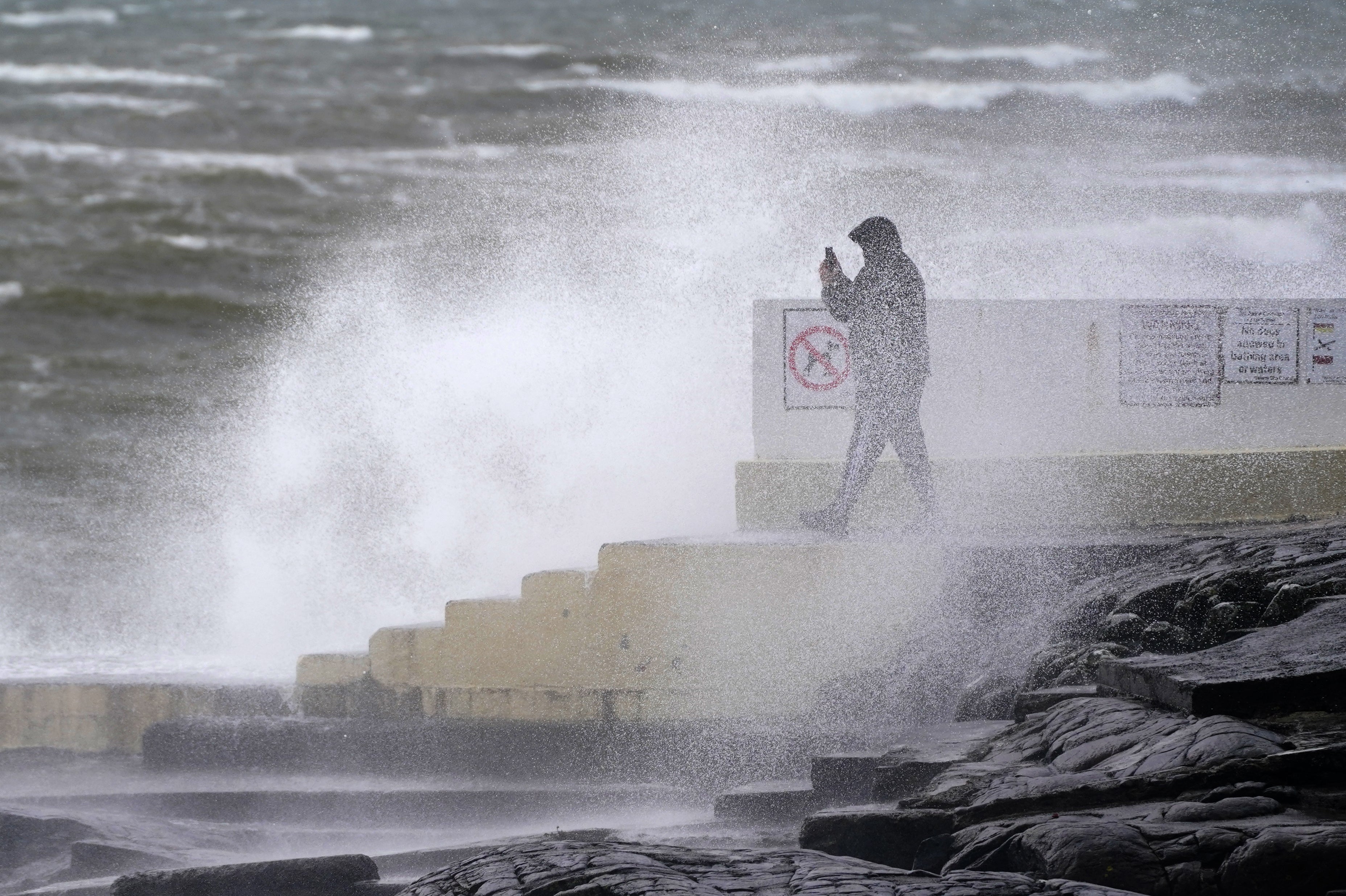 A man takes photos of the waves at Blackrock Diving Board, Salthill, Co. Galway