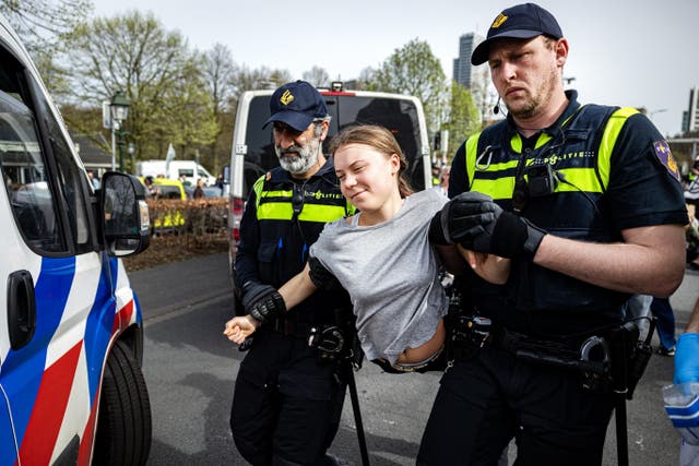 <p>Police detain Swedish climate activist Greta Thunberg during a climate march against fossil subsidies near highway A12 in the Hague, on 6 April 2024</p>