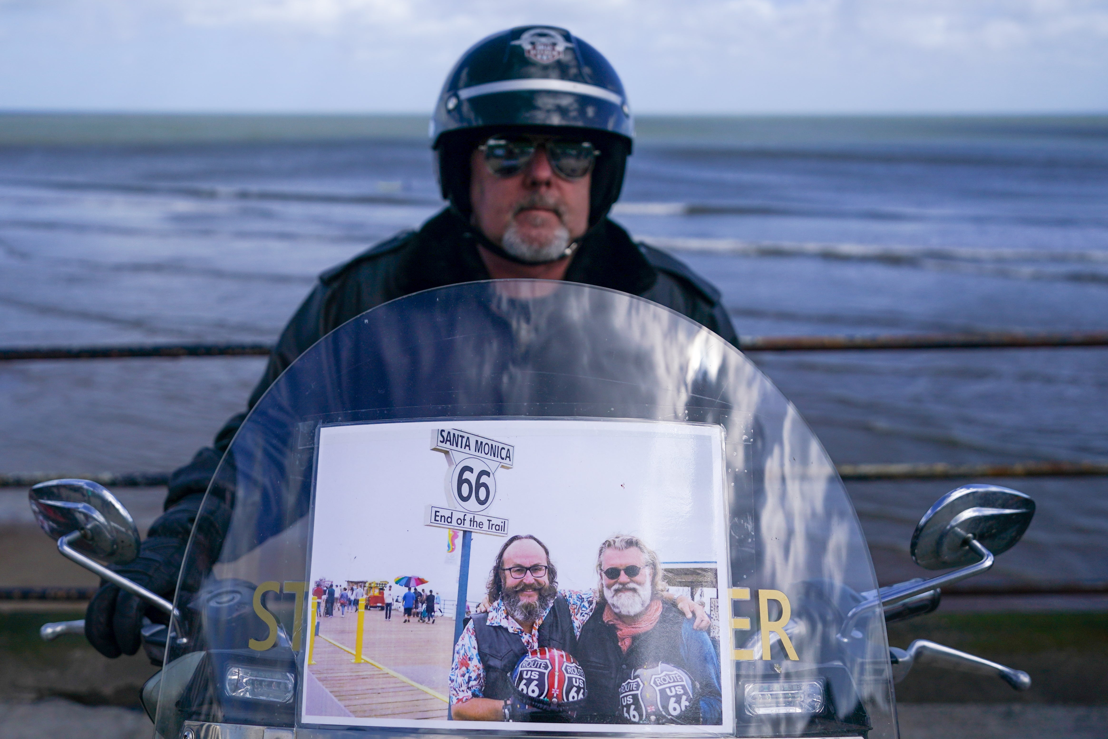 A biker parks his Harley Davidson motorcycle on the seafront as he arrives in Scarborough after completing a memorial bike ride for Dave Myers of the Hairy Bikers
