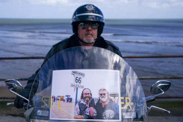 <p>A biker parks his Harley Davidson motorcycle on the seafront as he arrives in Scarborough after completing a memorial bike ride for Dave Myers of the Hairy Bikers </p>