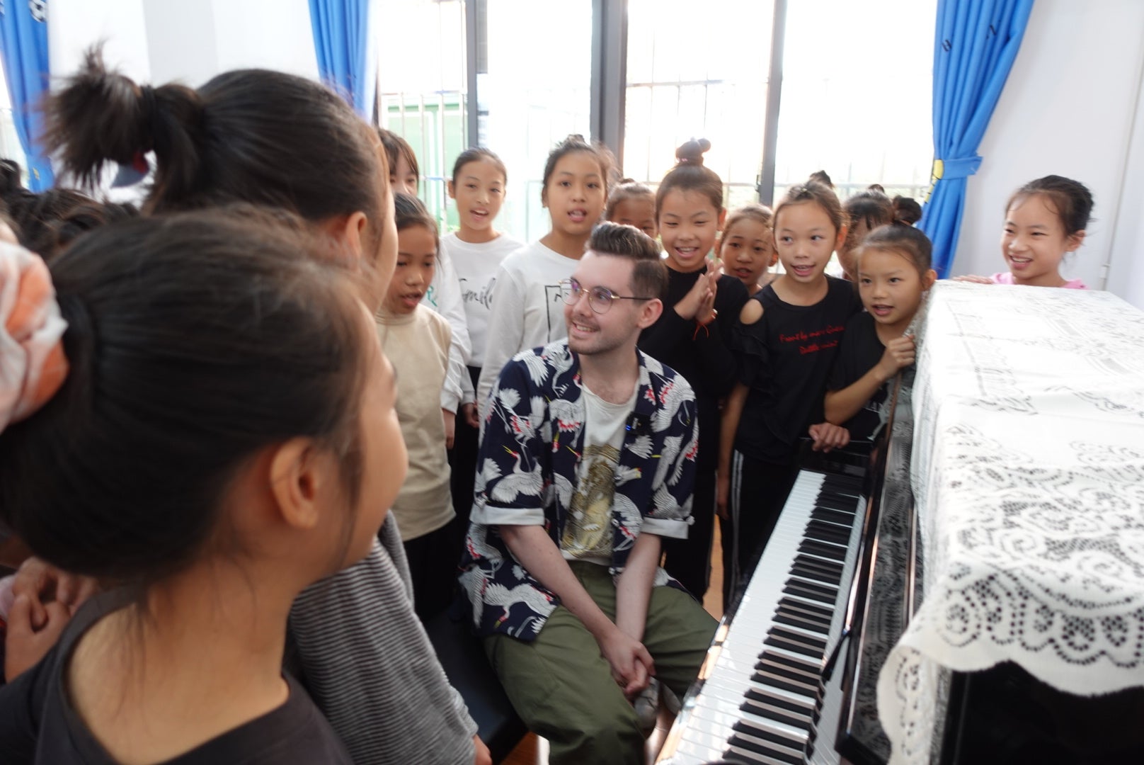 Gibson plays the piano with children in a primary school in South China’s Guangxi Zhuang autonomous region in 2020
