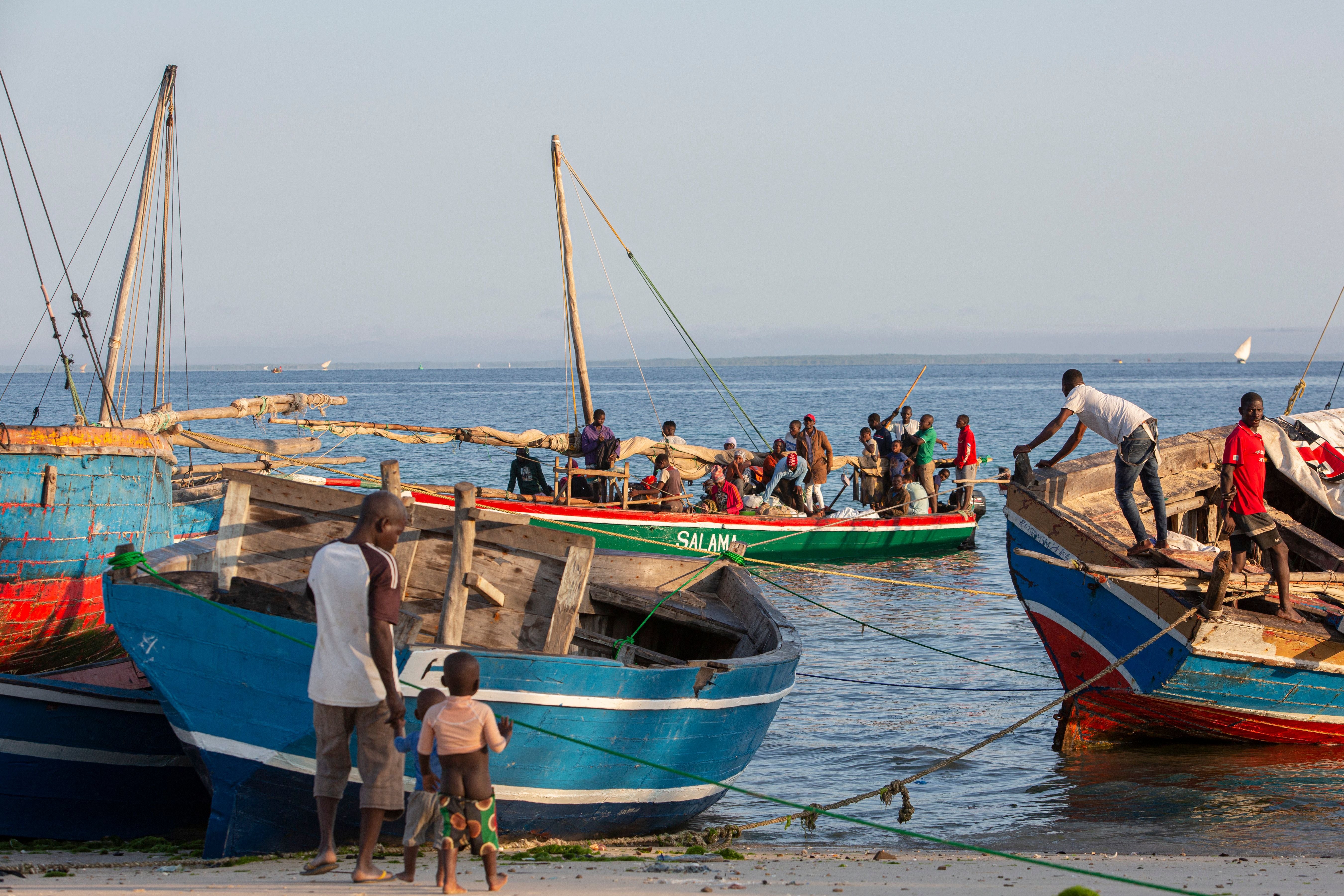 File: Fishermen tend to their boats on shores of Paquitequete neighborhood in Pemba